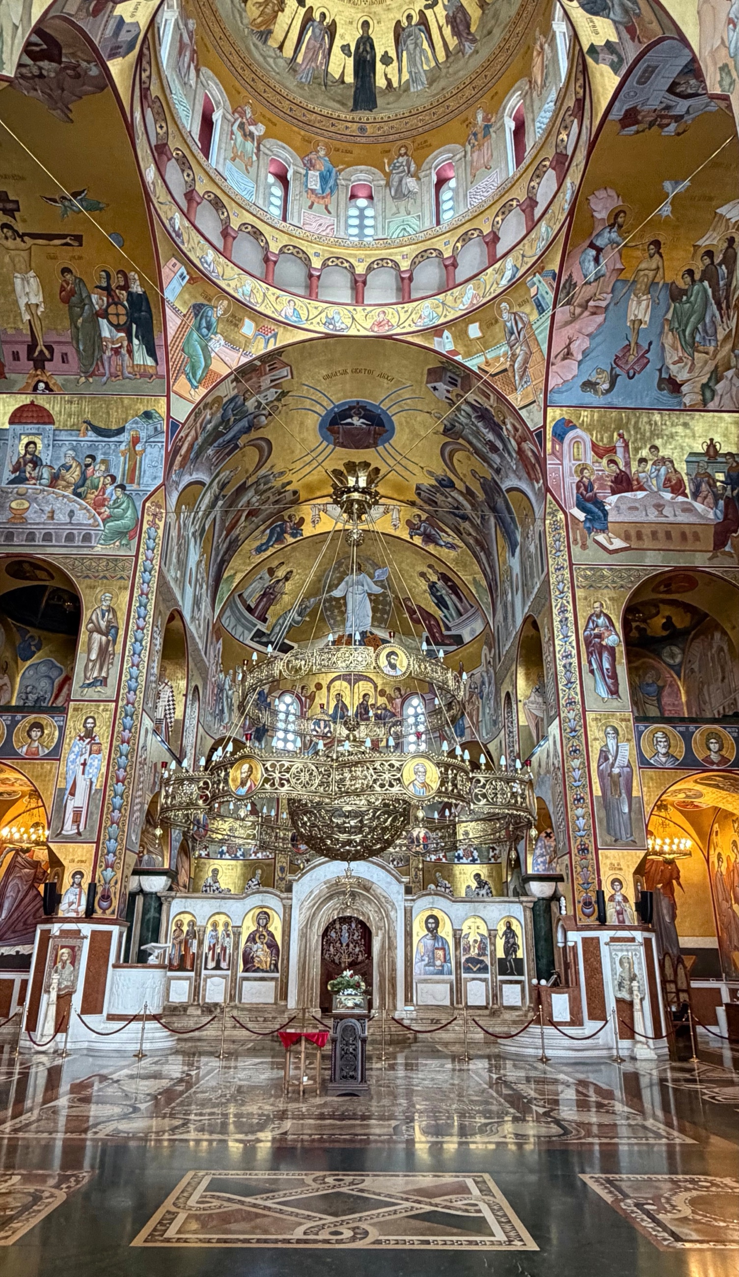 Interior of the Cathedral of the Resurrection of Christ in Podgorica with gold-backed frescoes and chandeliers