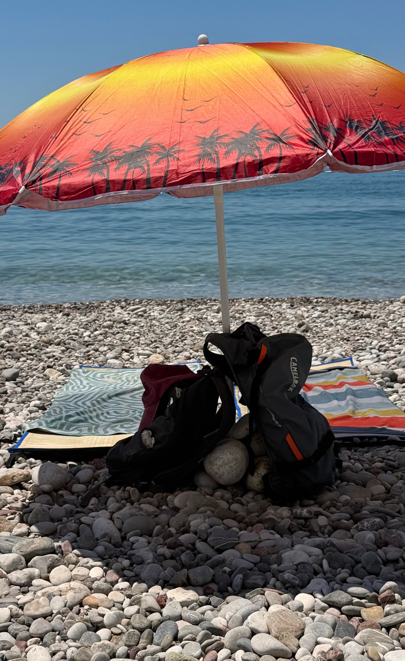 Summer beach setup in Bar with mats and an umbrella