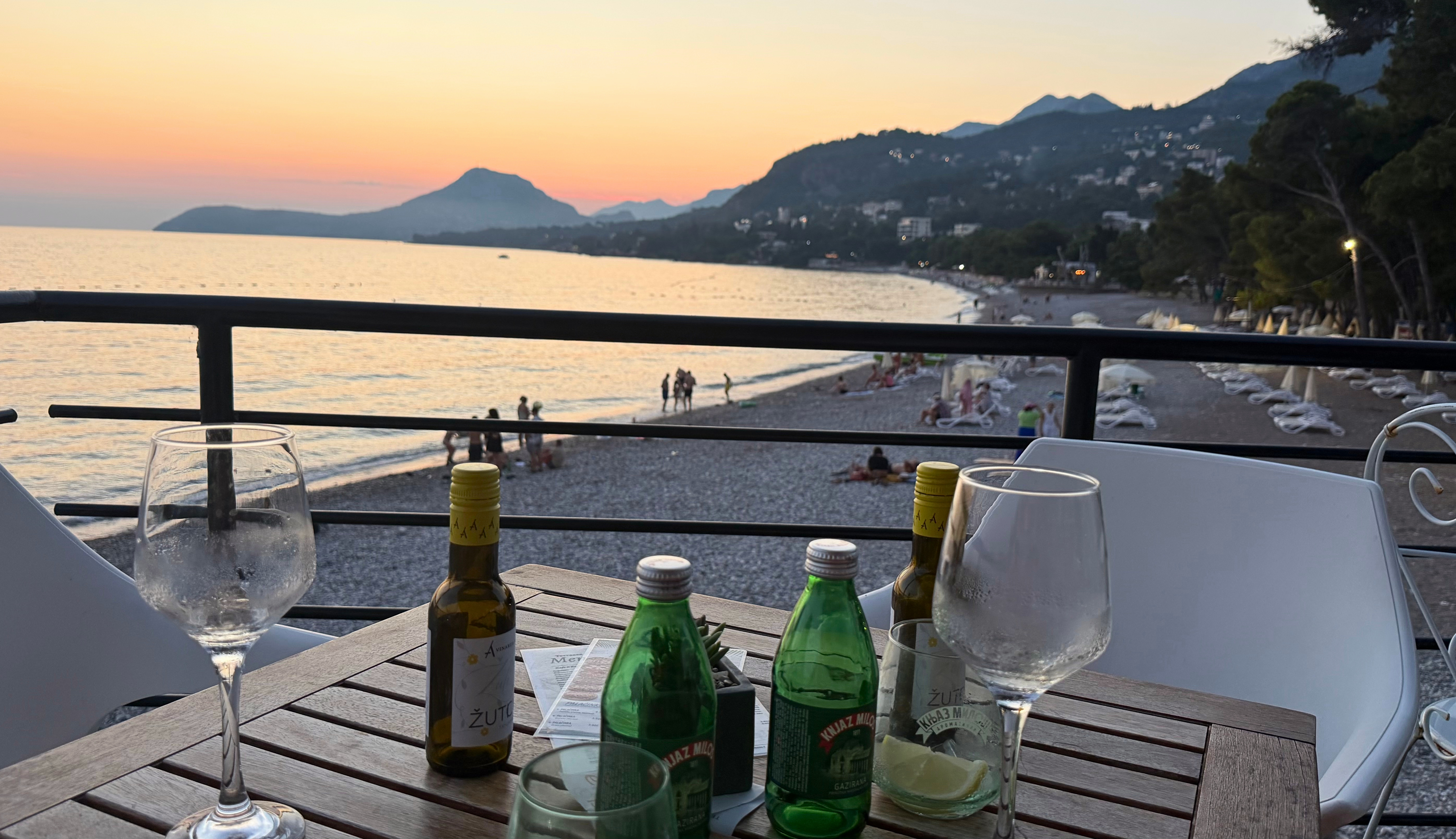A sunset table above Šušanj Beach with wine and mineral water.