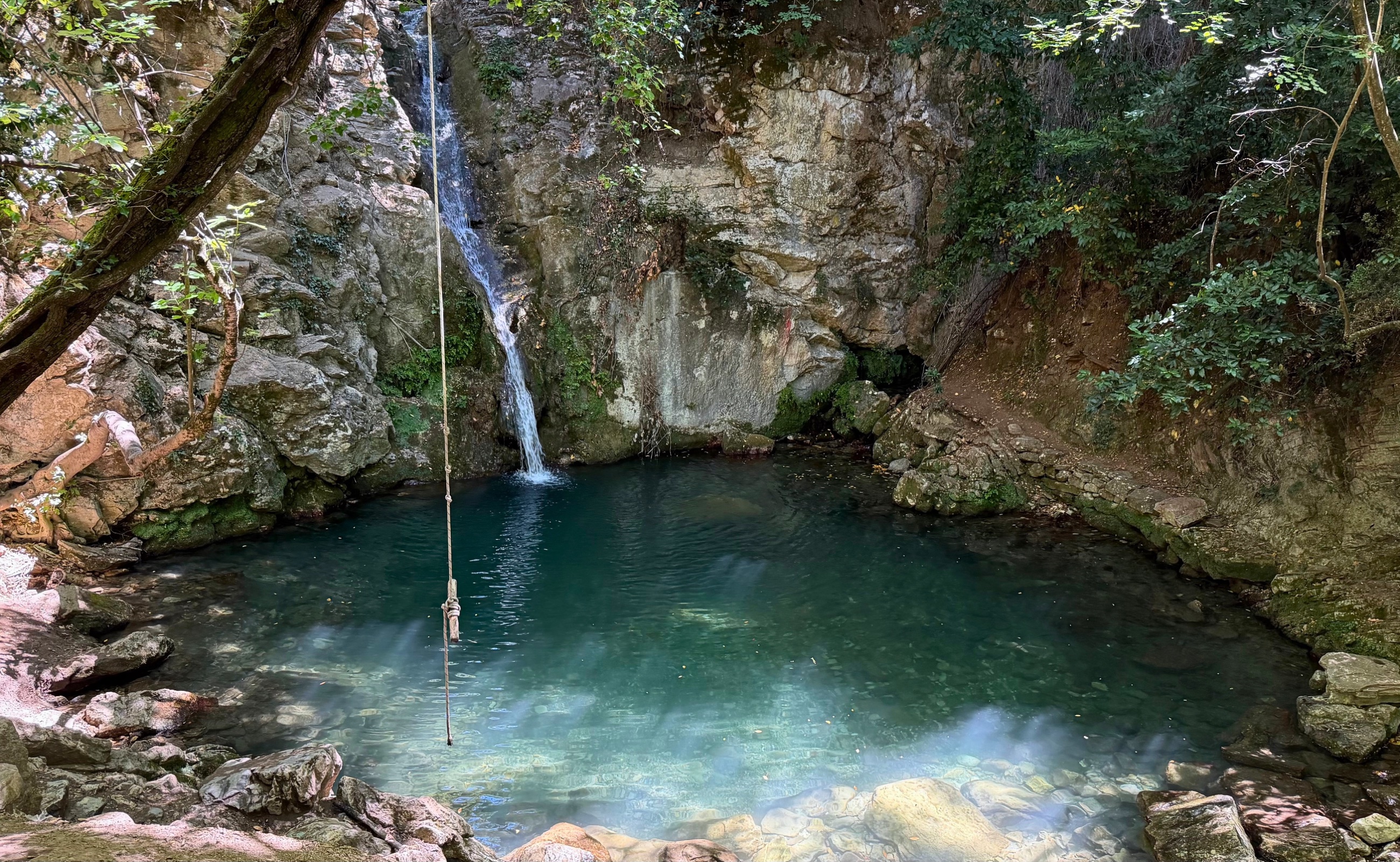 Vrteljak waterfall and the clear Blue Lagoon pool in the wooded hills above Stari Bar