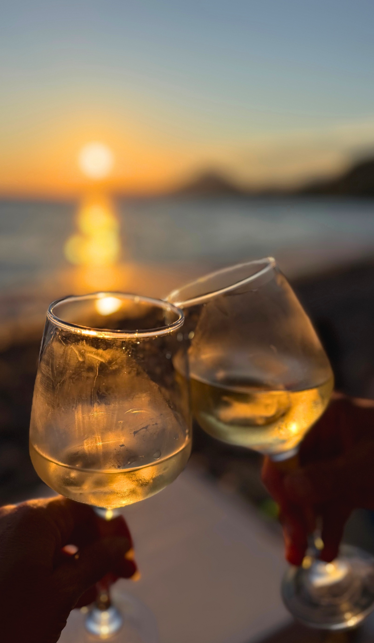 A glass of local wine near the coast at sunset
