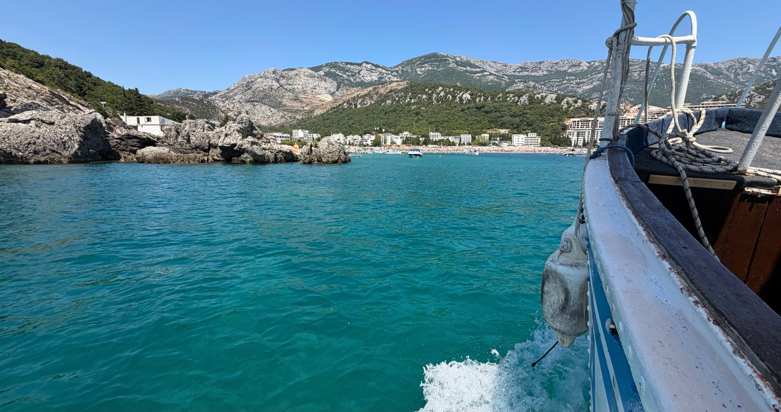 A boat near Čanj with mountains above the blue-green Adriatic