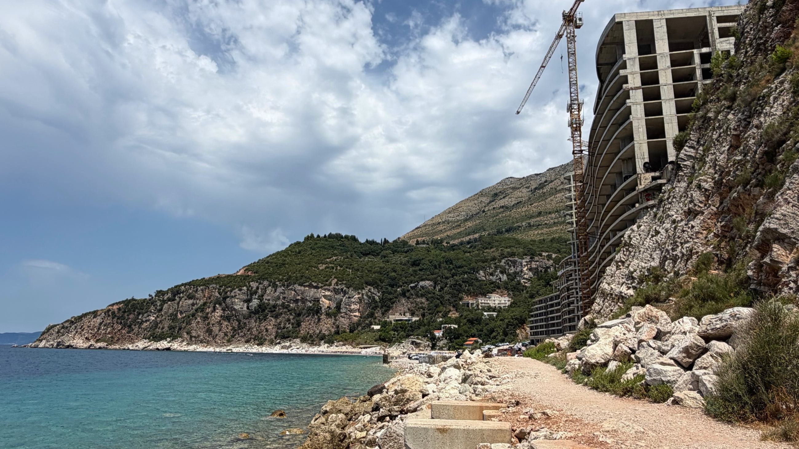 The unfinished Hotel AS built into the cliff above Perazića Do Beach.