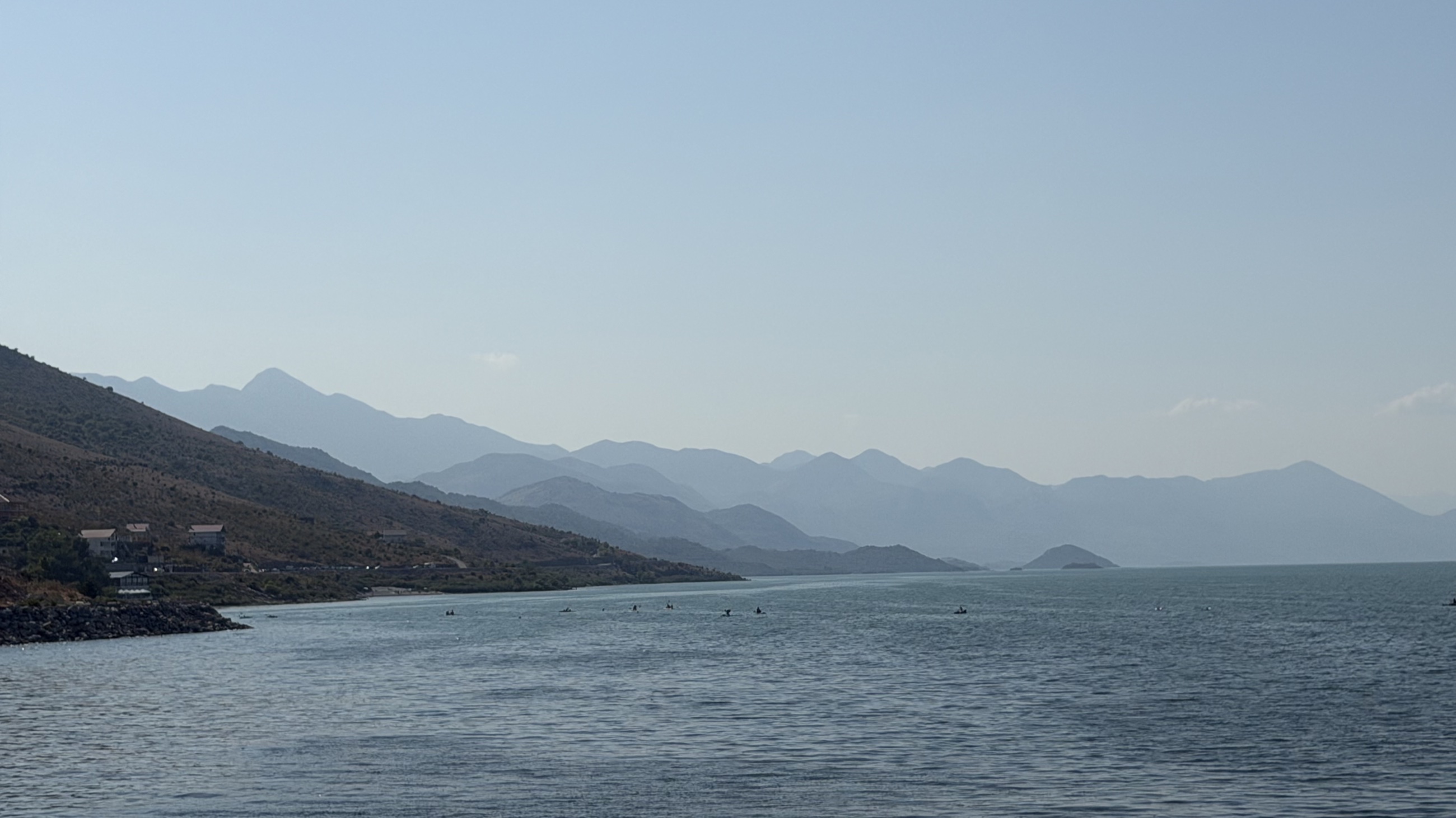 Lake Shkodër stretching toward the layered peaks of the Albanian Alps.