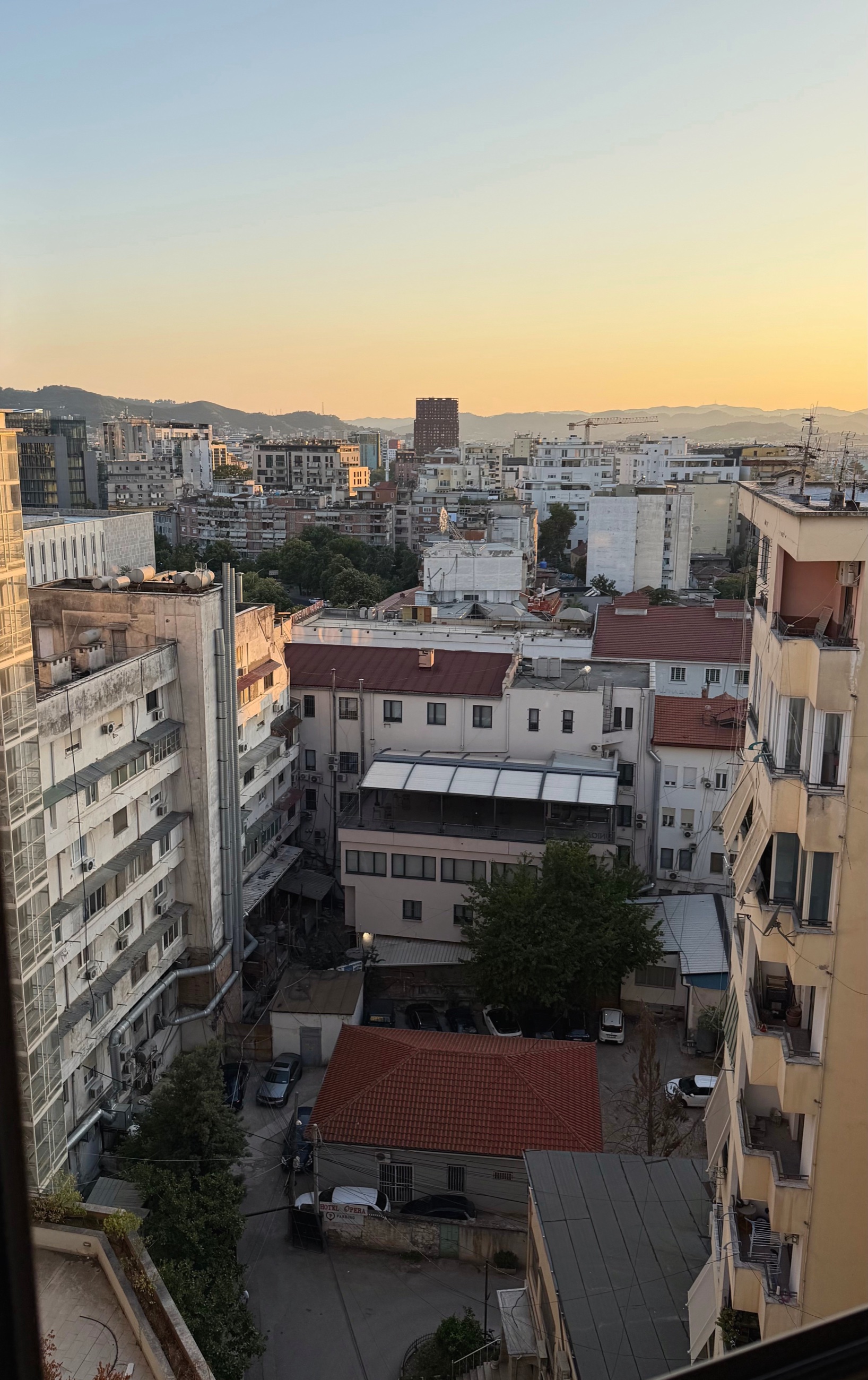 Tirana at sunset from the window of our new apartment.