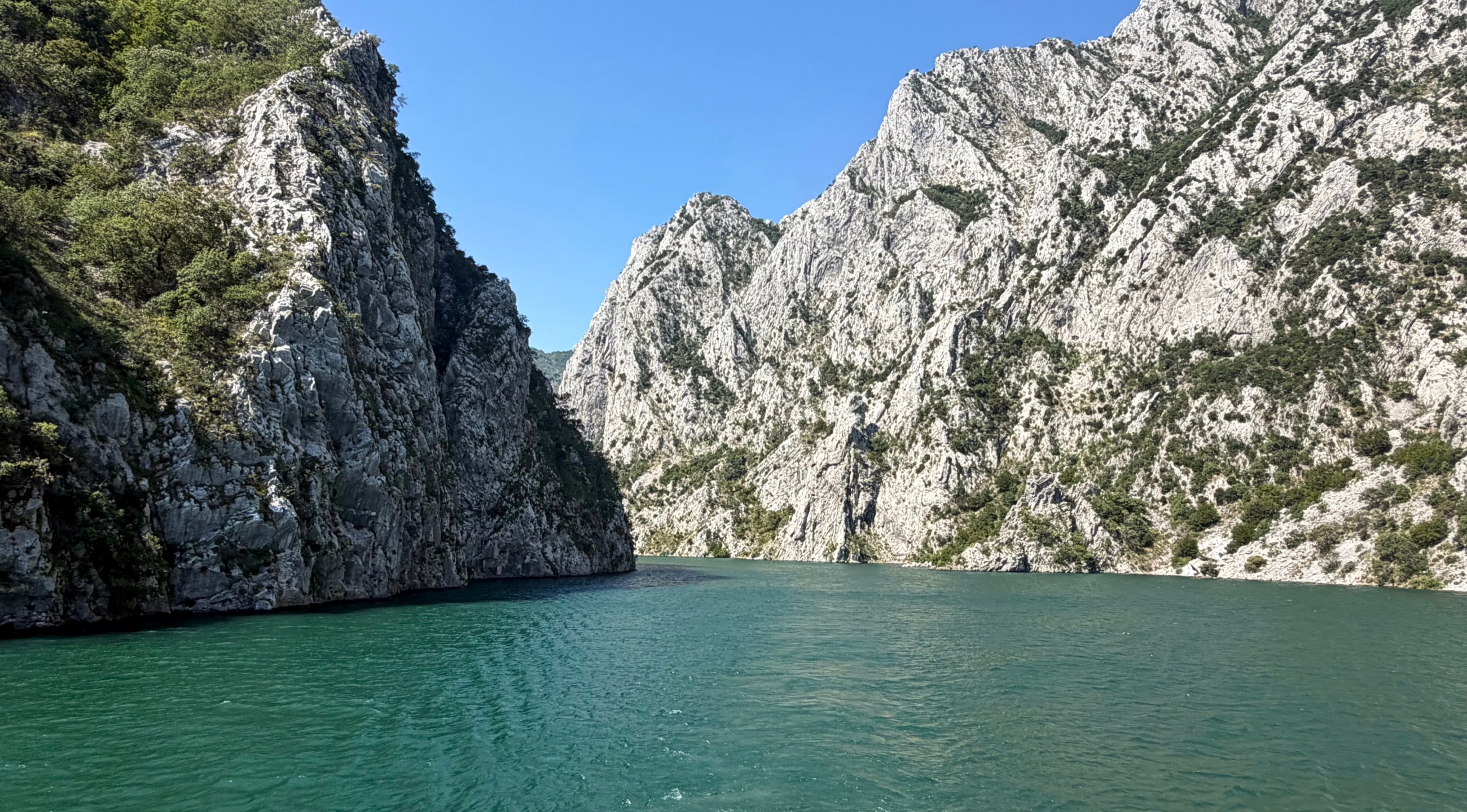 Komani Lake narrowing between steep limestone cliffs along the ferry route north from Tirana.