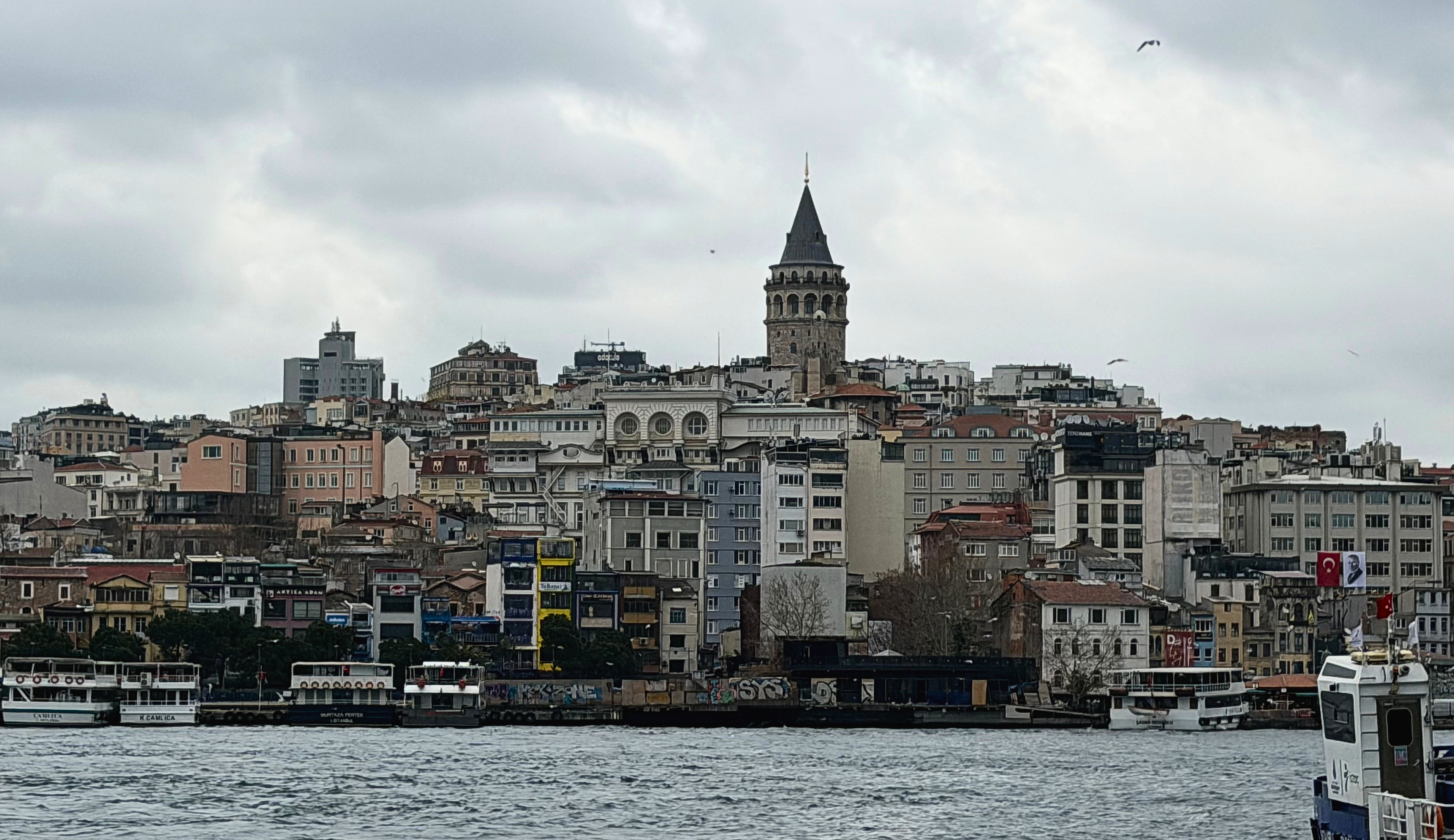 Galata Tower rising above buildings near the Istanbul waterfront.