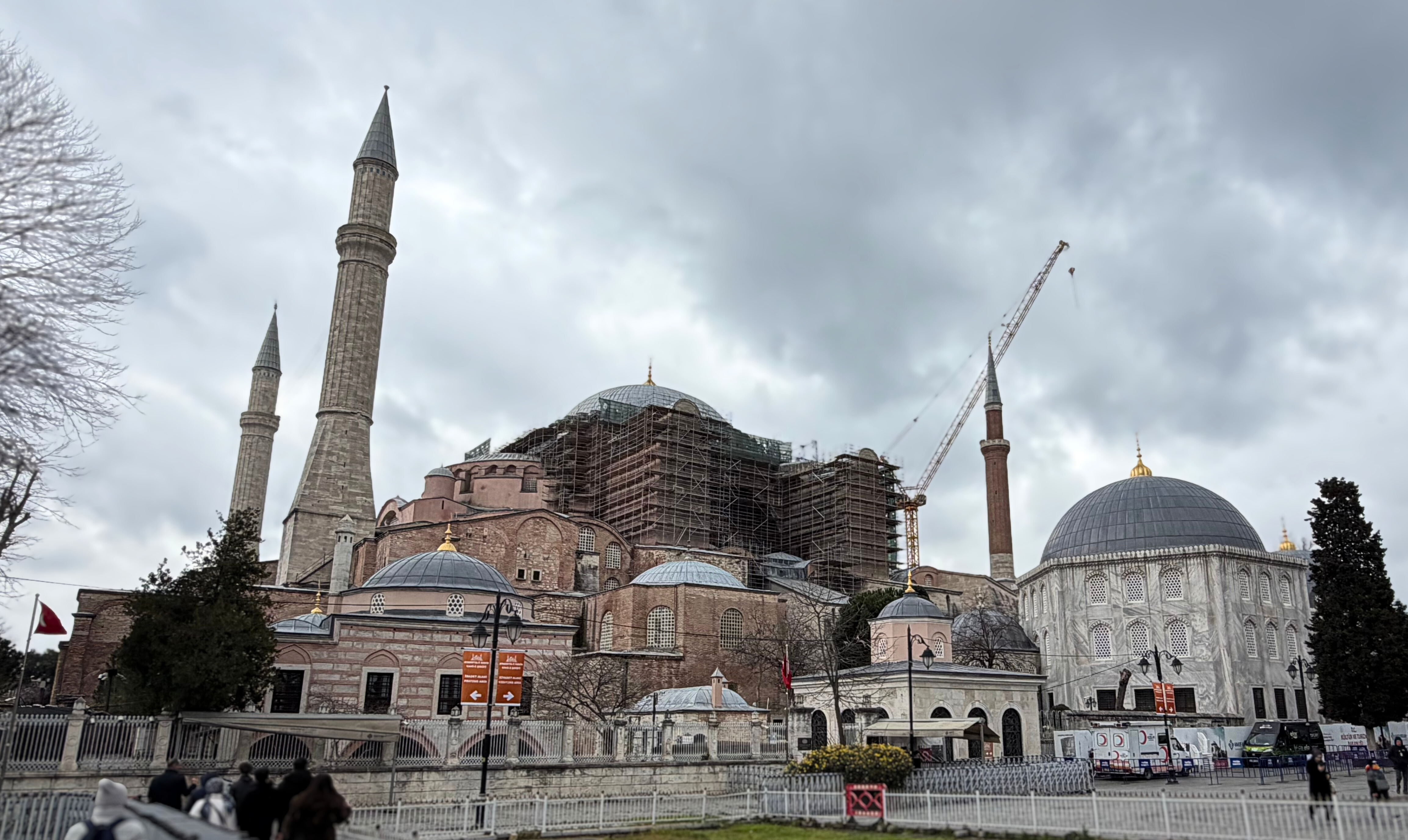 Hagia Sophia under scaffolding beneath a cloudy sky in Istanbul.