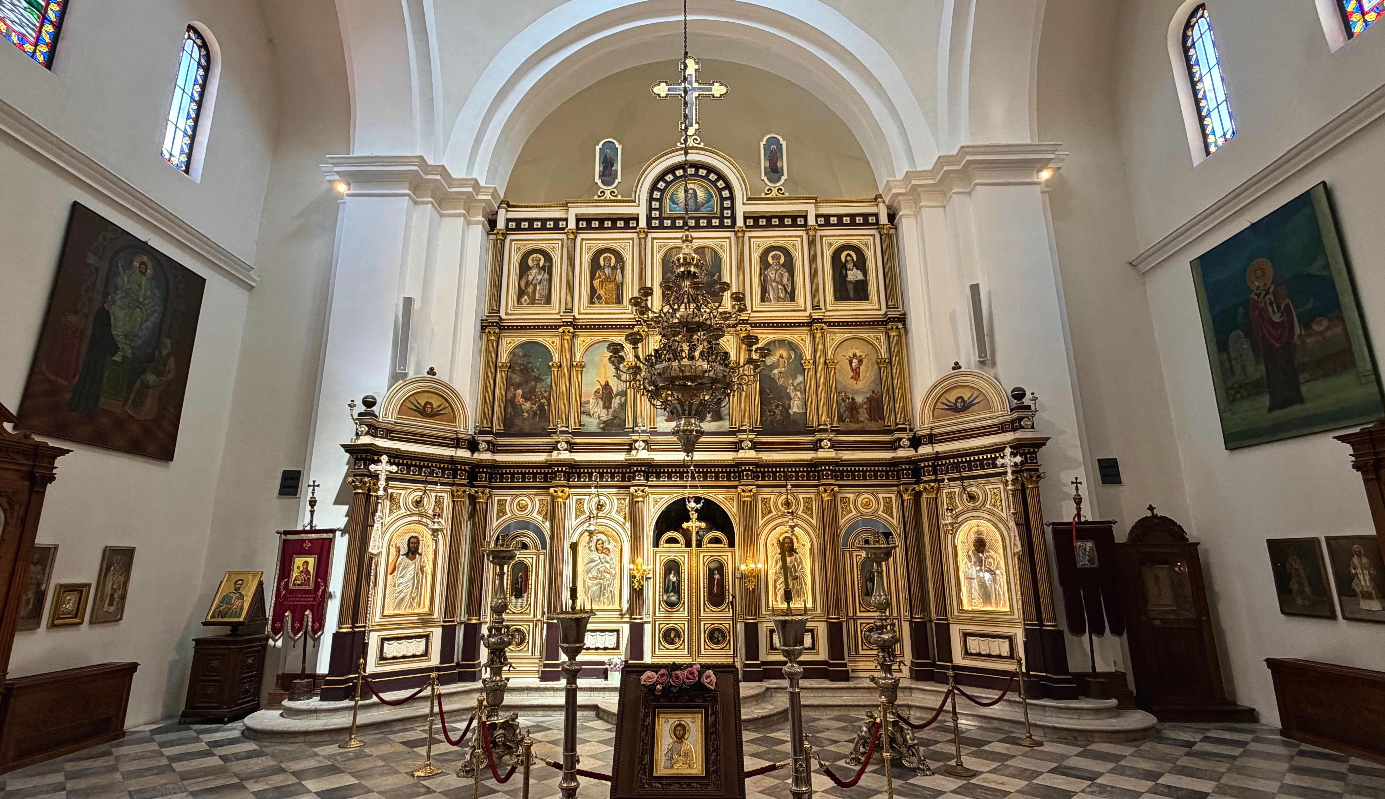 Inside St. Nicholas, the gilded iconostasis and painted icons of the Serbian Orthodox church.