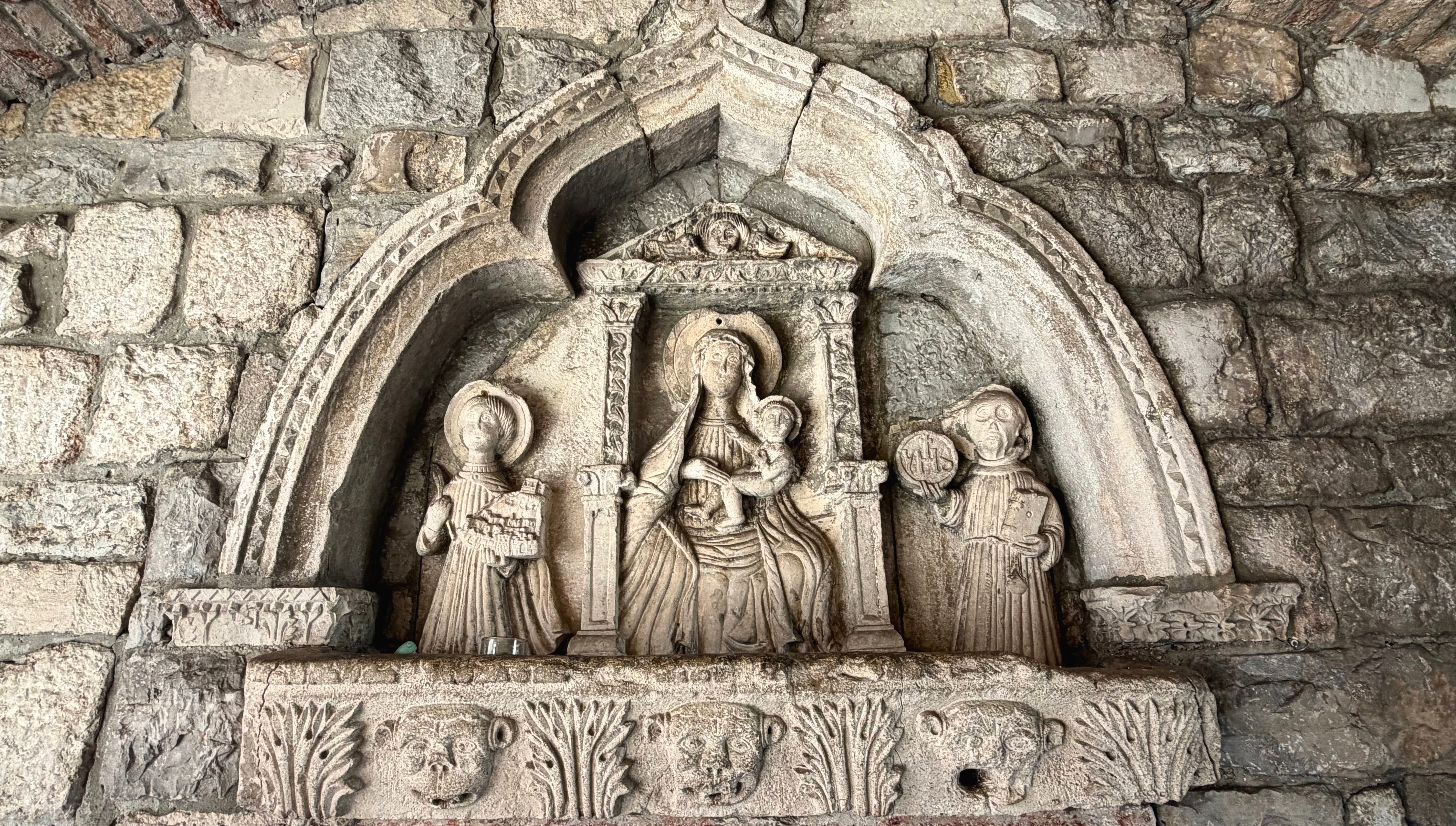 A carved stone relief set inside Kotor's Sea Gate passage.