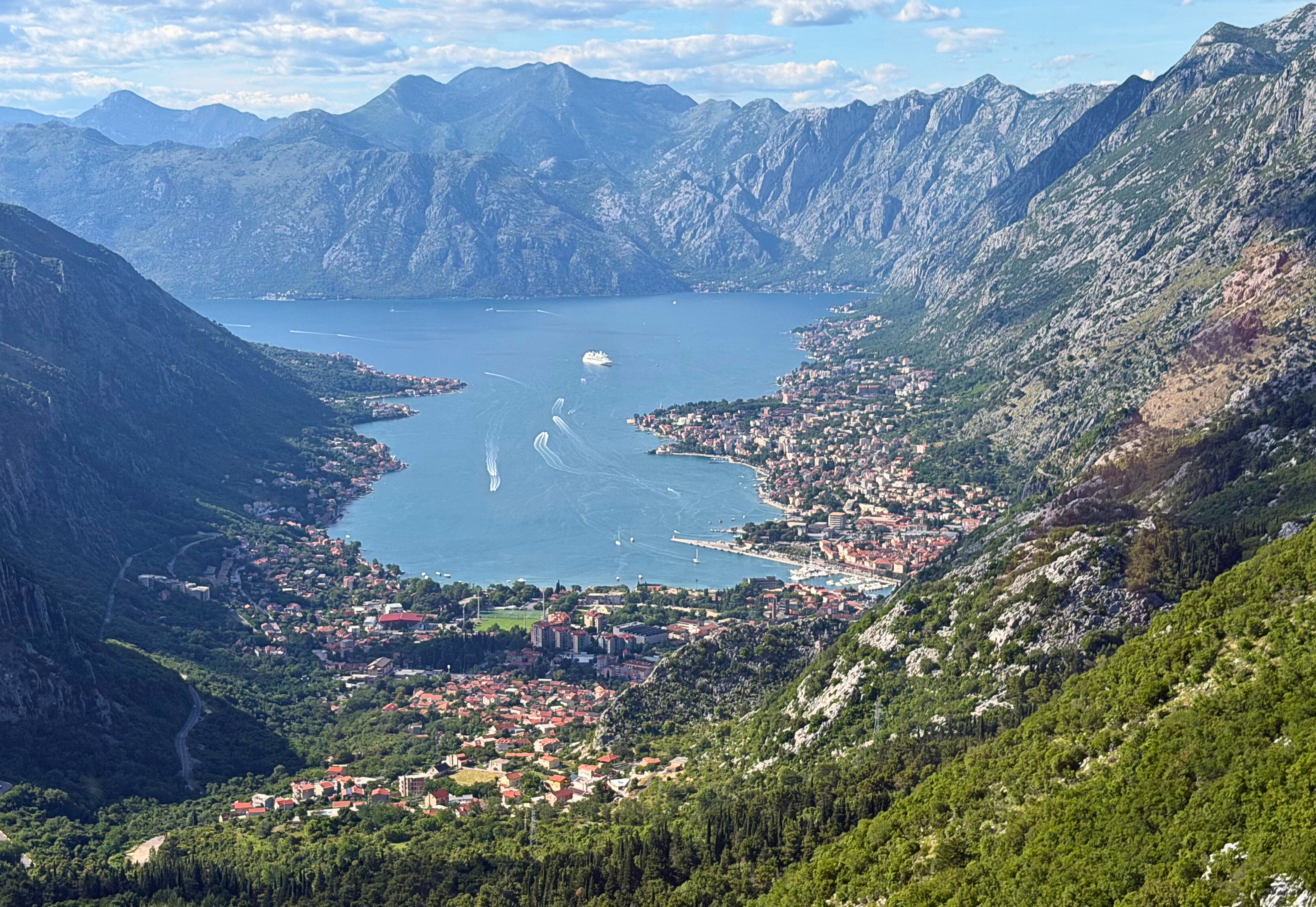 The Bay of Kotor seen from the cable car, with Kotor below, Dobrota along the shoreline, and mountains dropping to the water