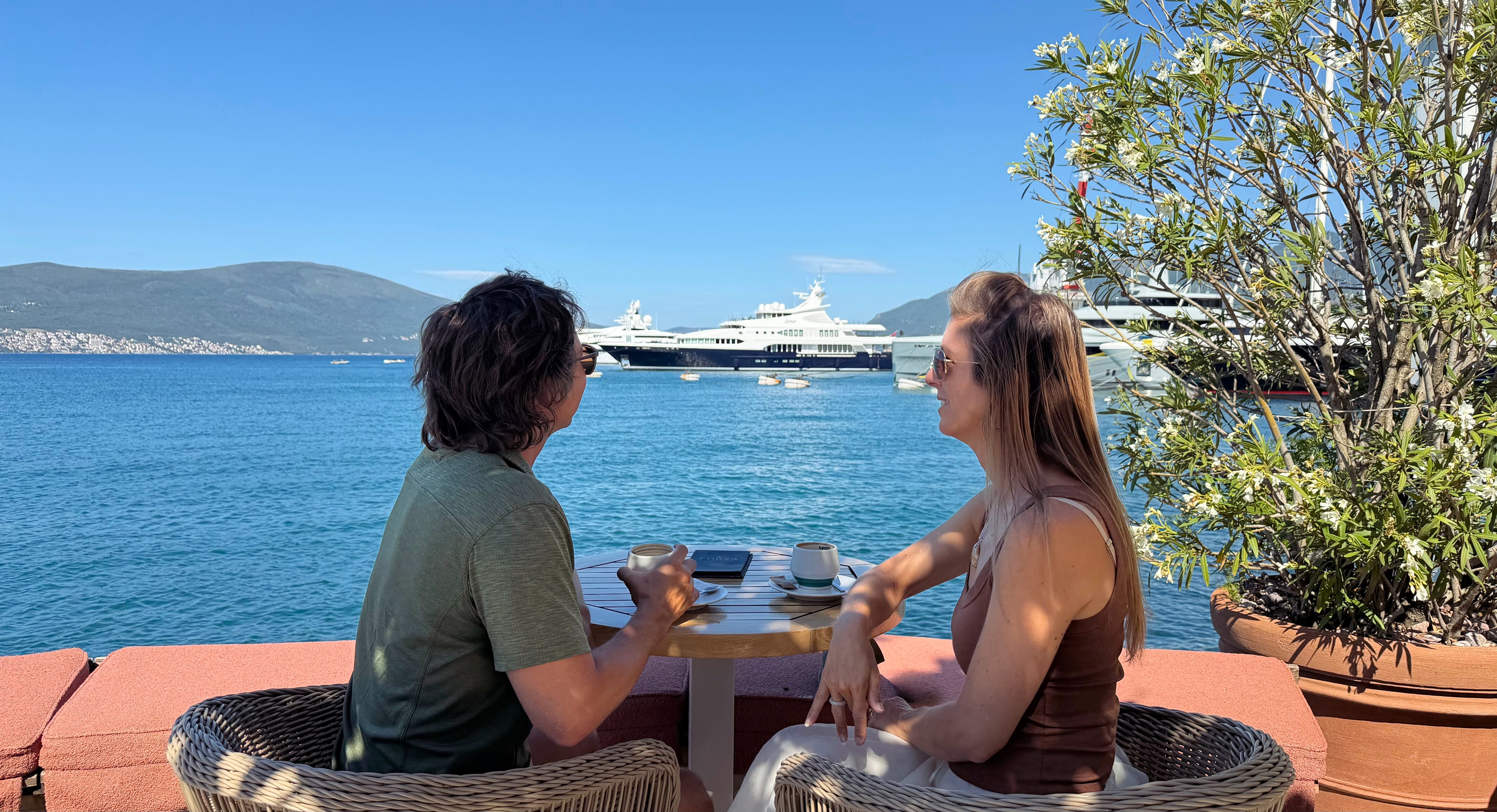 A marina-side coffee break in Tivat, with luxury yachts behind