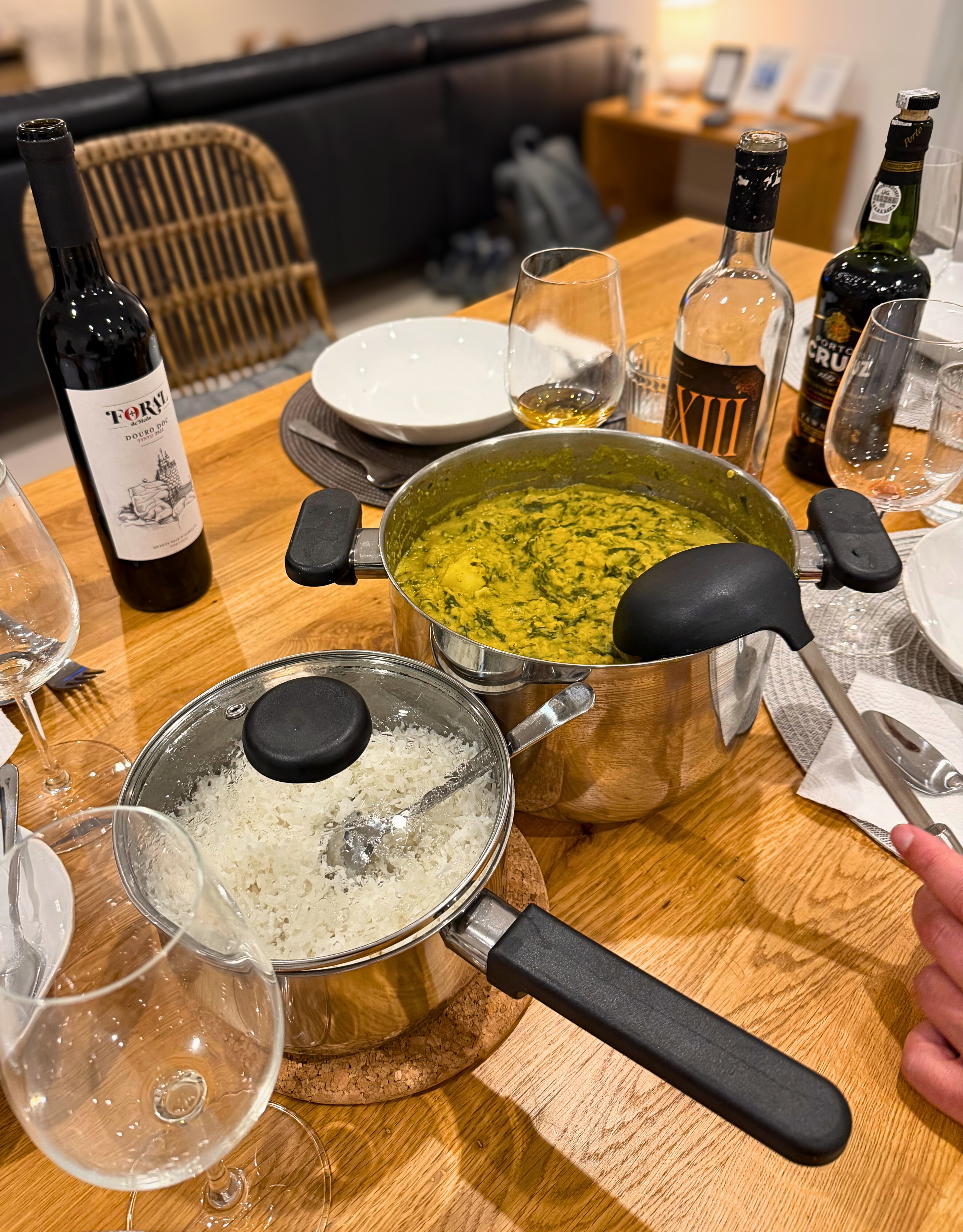 A shared dinner table with dhal, rice, wine, and port at home in Lagos.