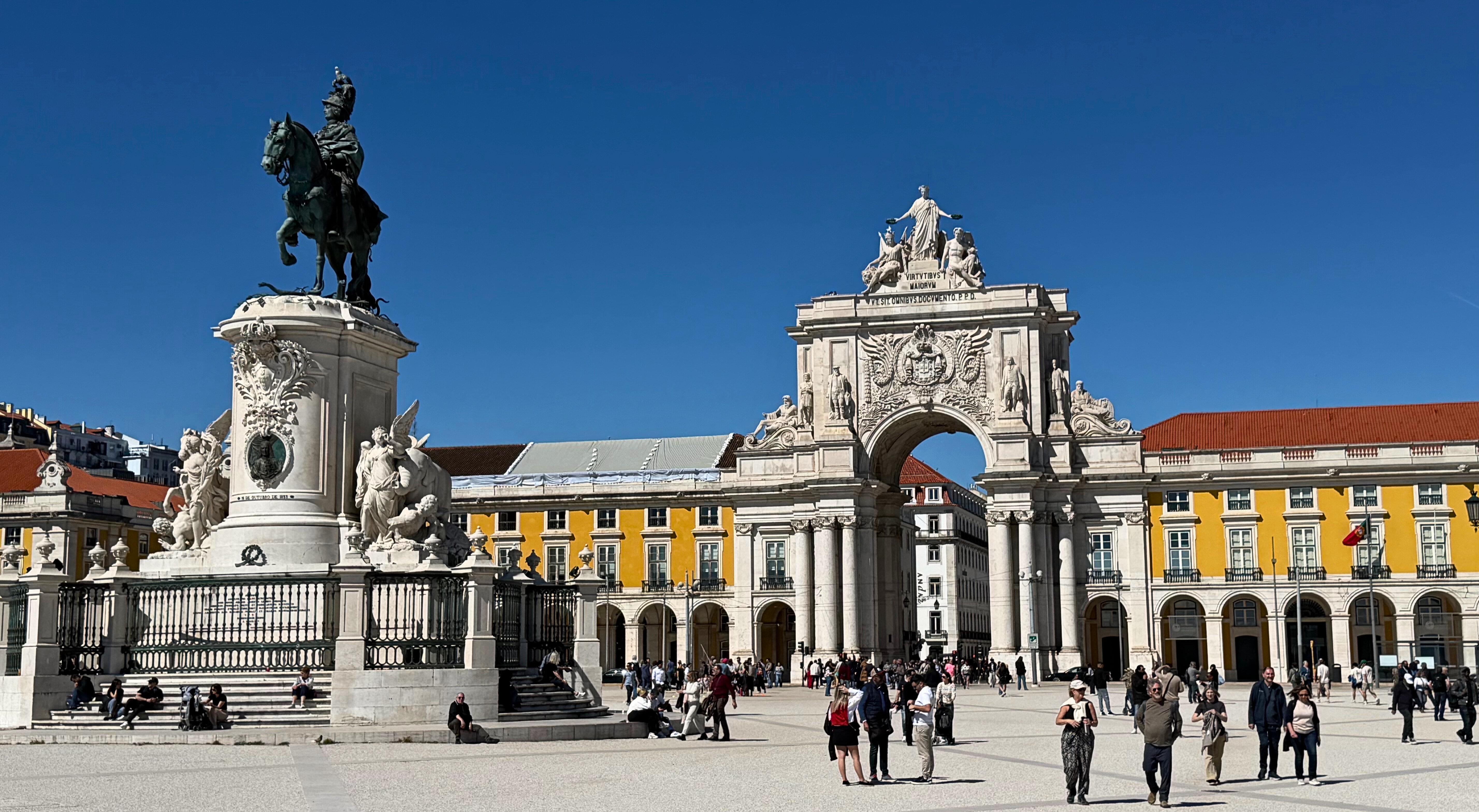Praça do Comércio in Lisbon with its large open square, arcades, and the equestrian statue at the center.
