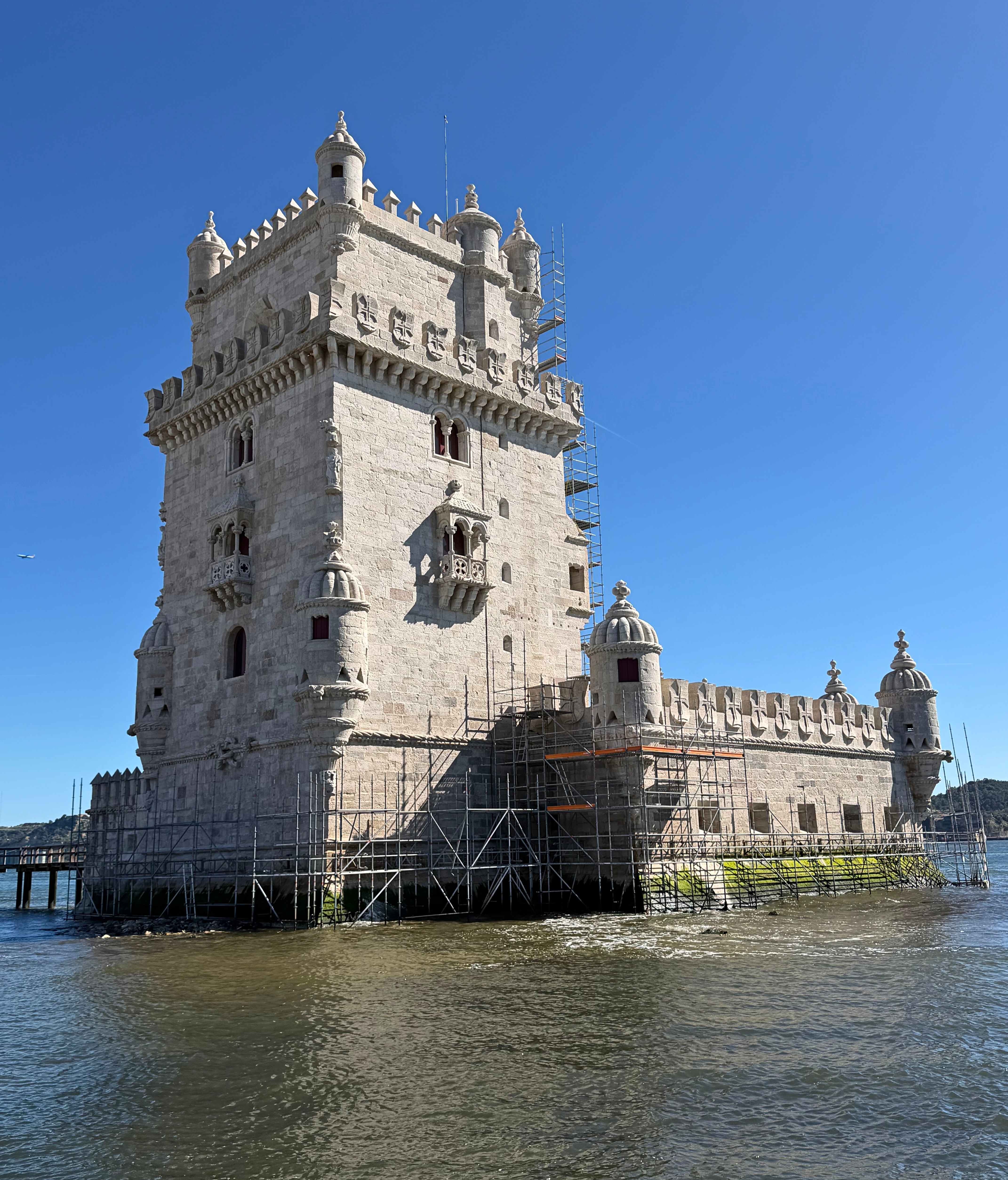 Belém Tower standing at the edge of the Tagus river.