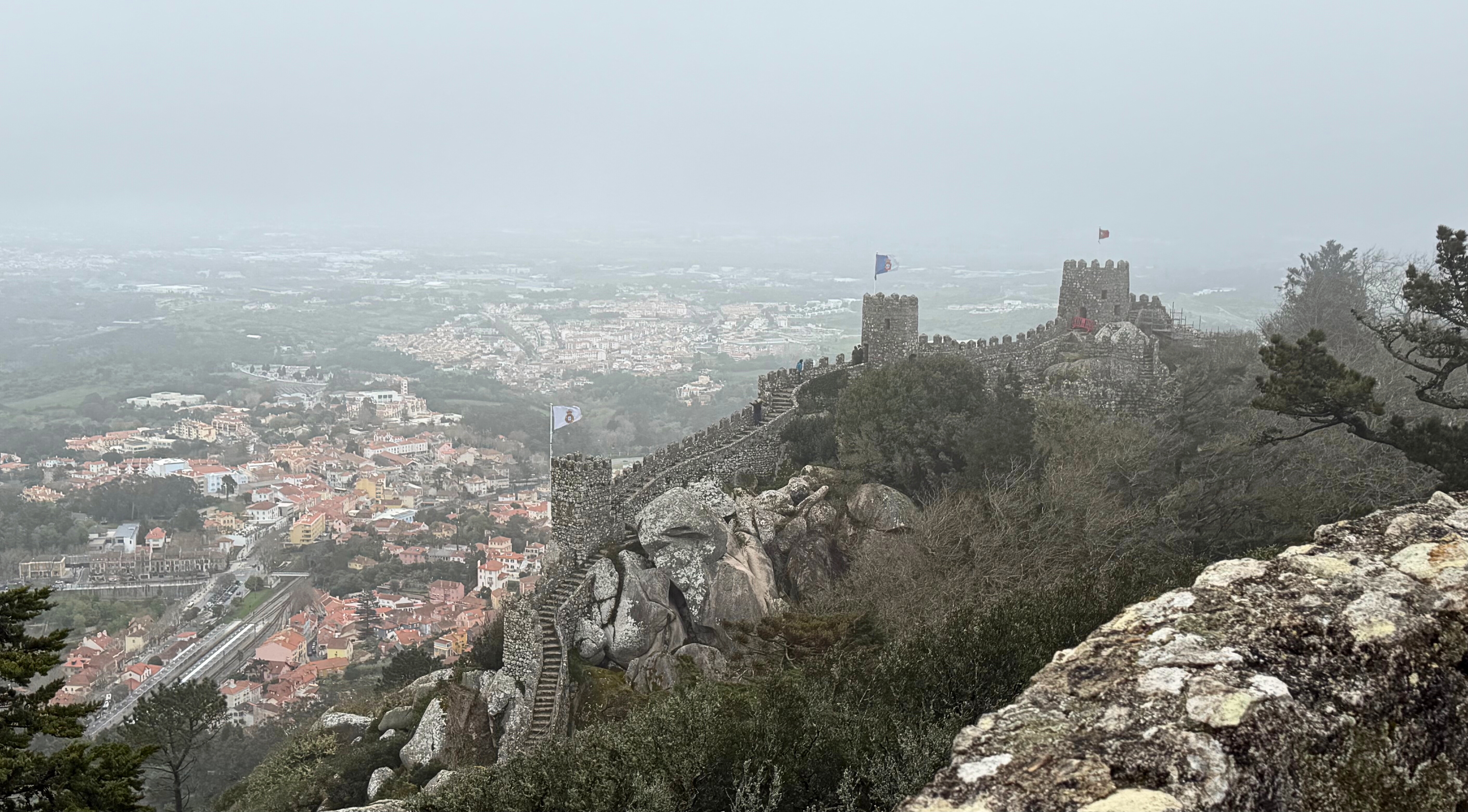 The Moorish Castle in Sintra with ramparts fading into mist over the valley.