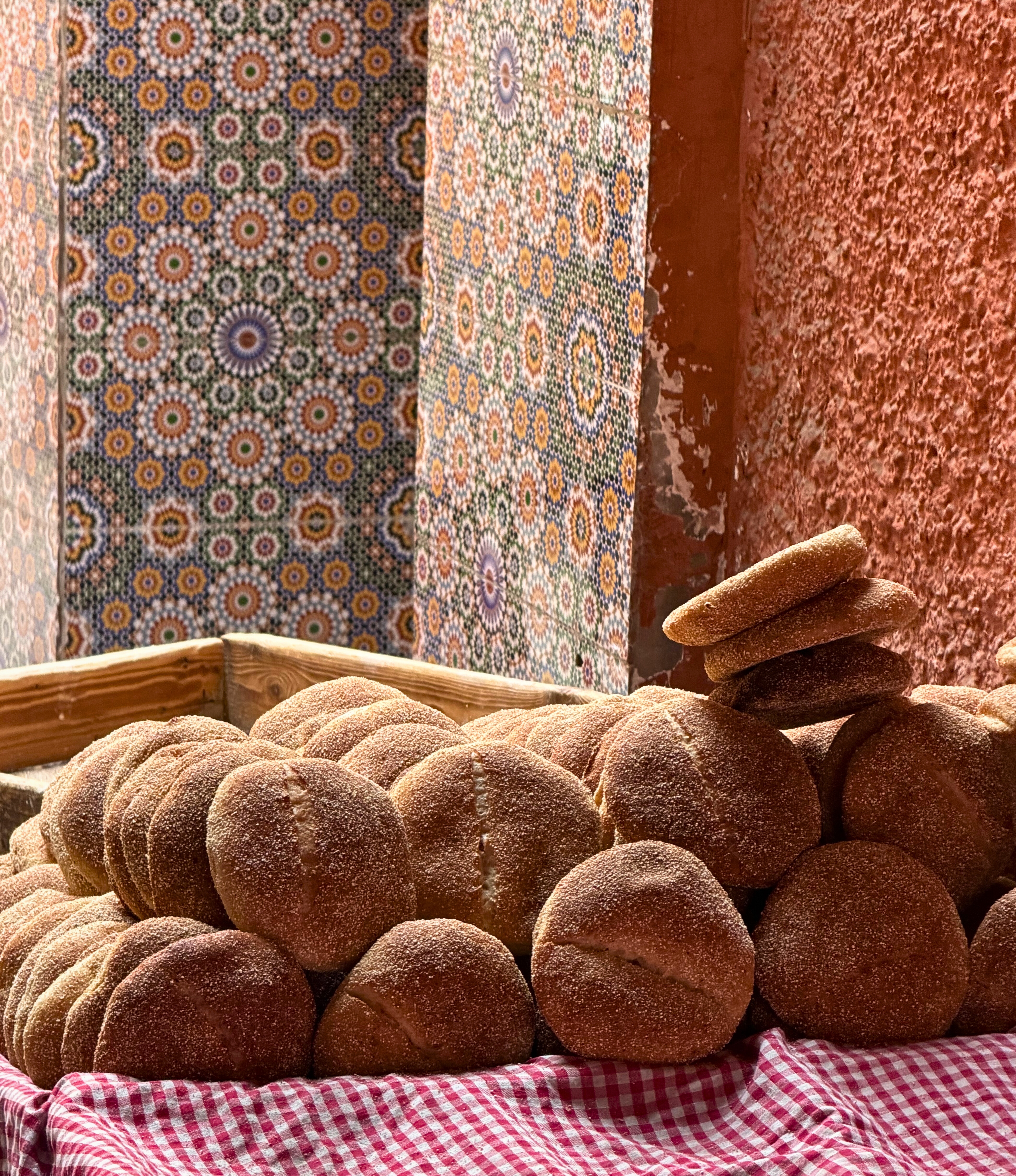 Round loaves of bread stacked on a cart in Marrakesh.