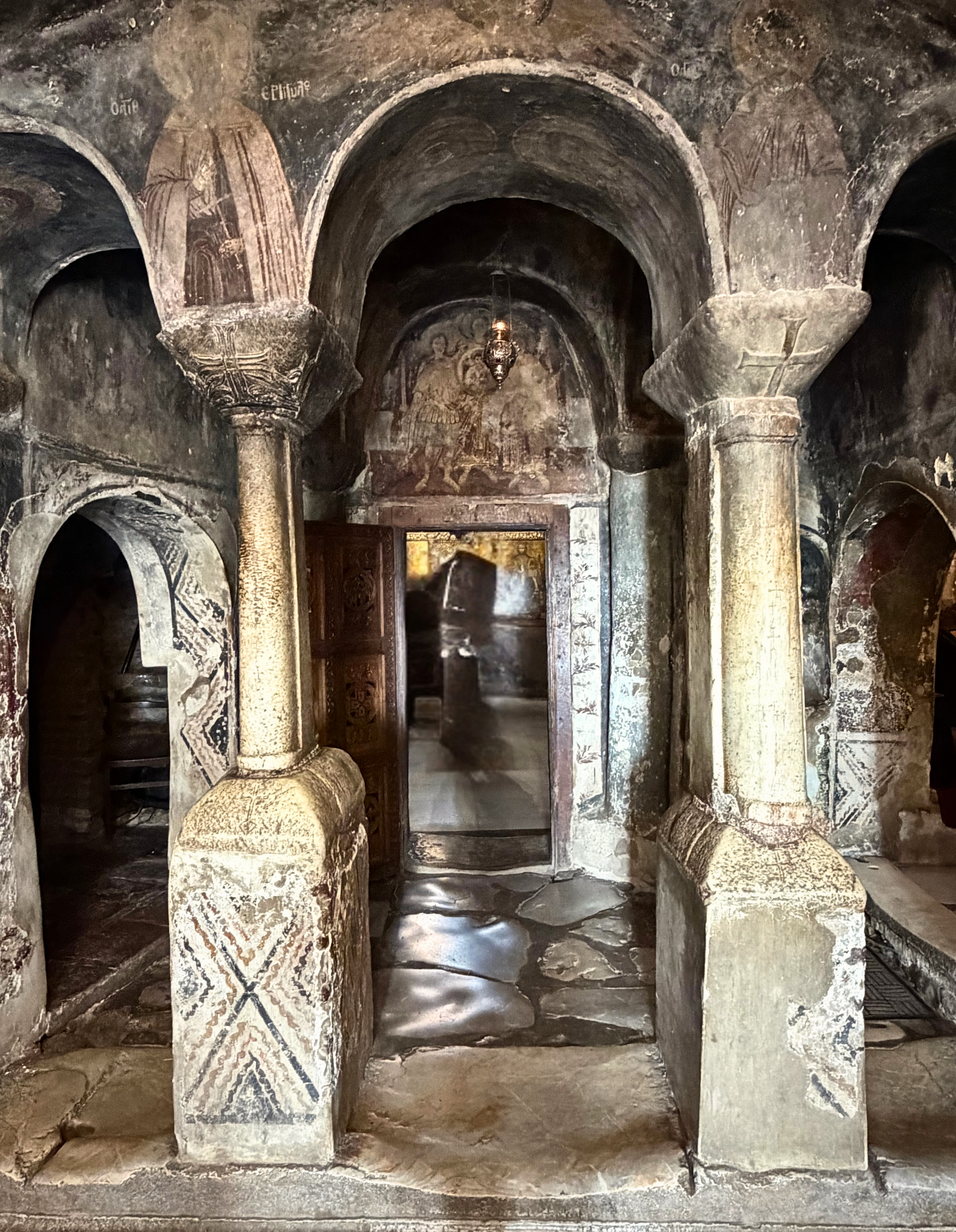 Interior of Saint Naum with stone and fading frescoes