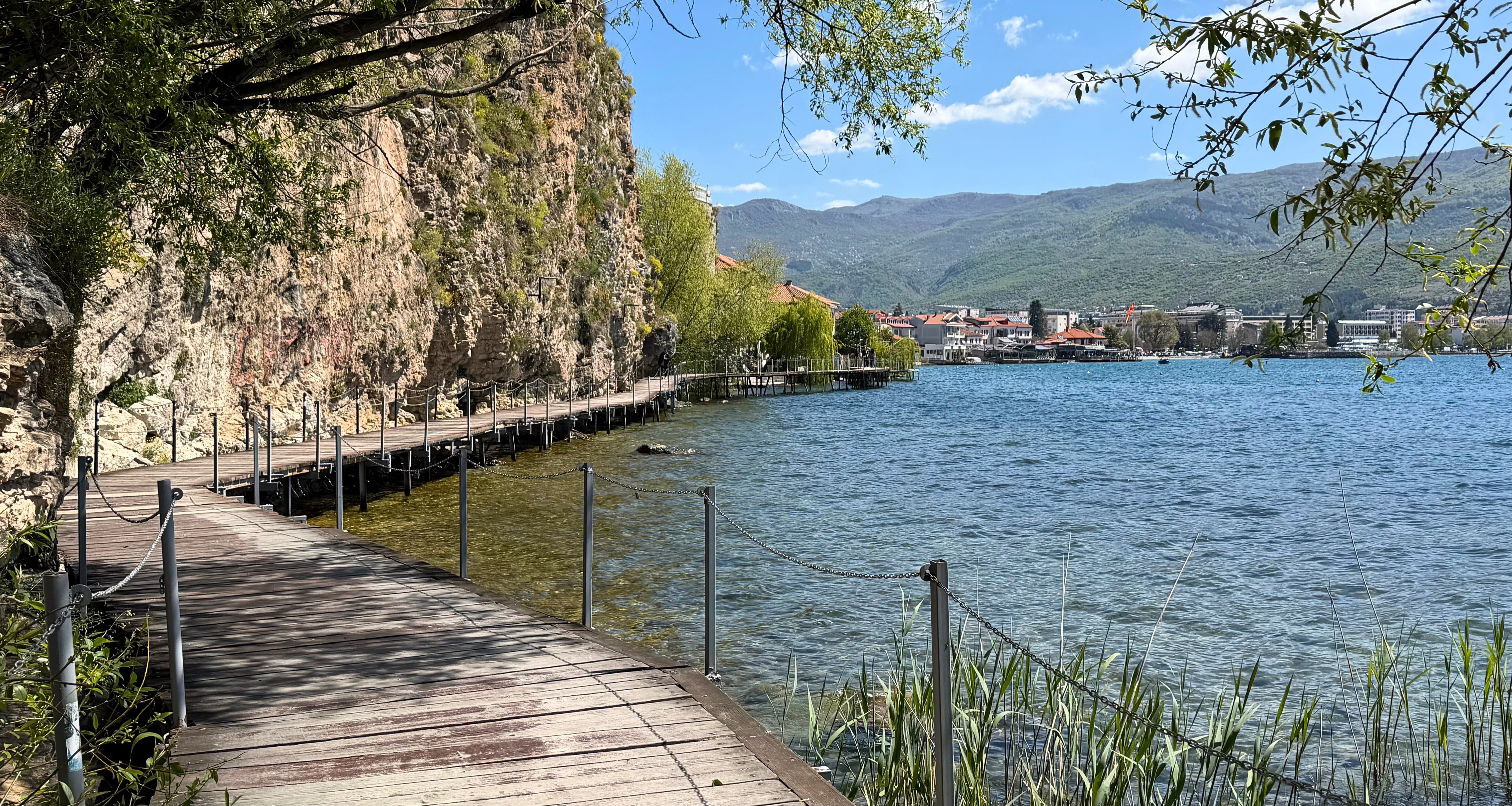 The wooden lakeside boardwalk below the cliffs on the route toward Saint Jovan in Ohrid.