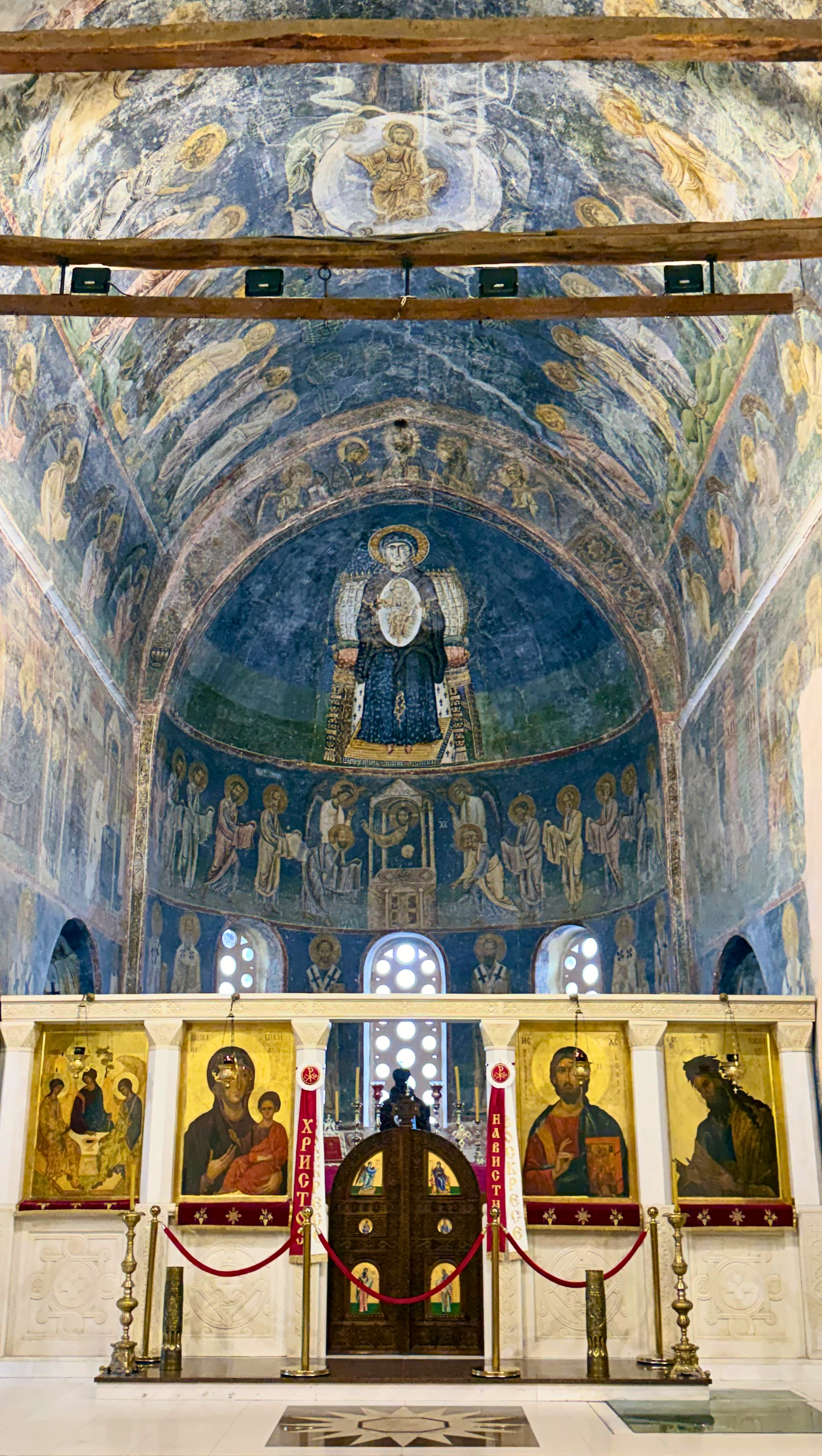 Interior of Saint Sophia church in Ohrid with stone arches and historic frescoes.