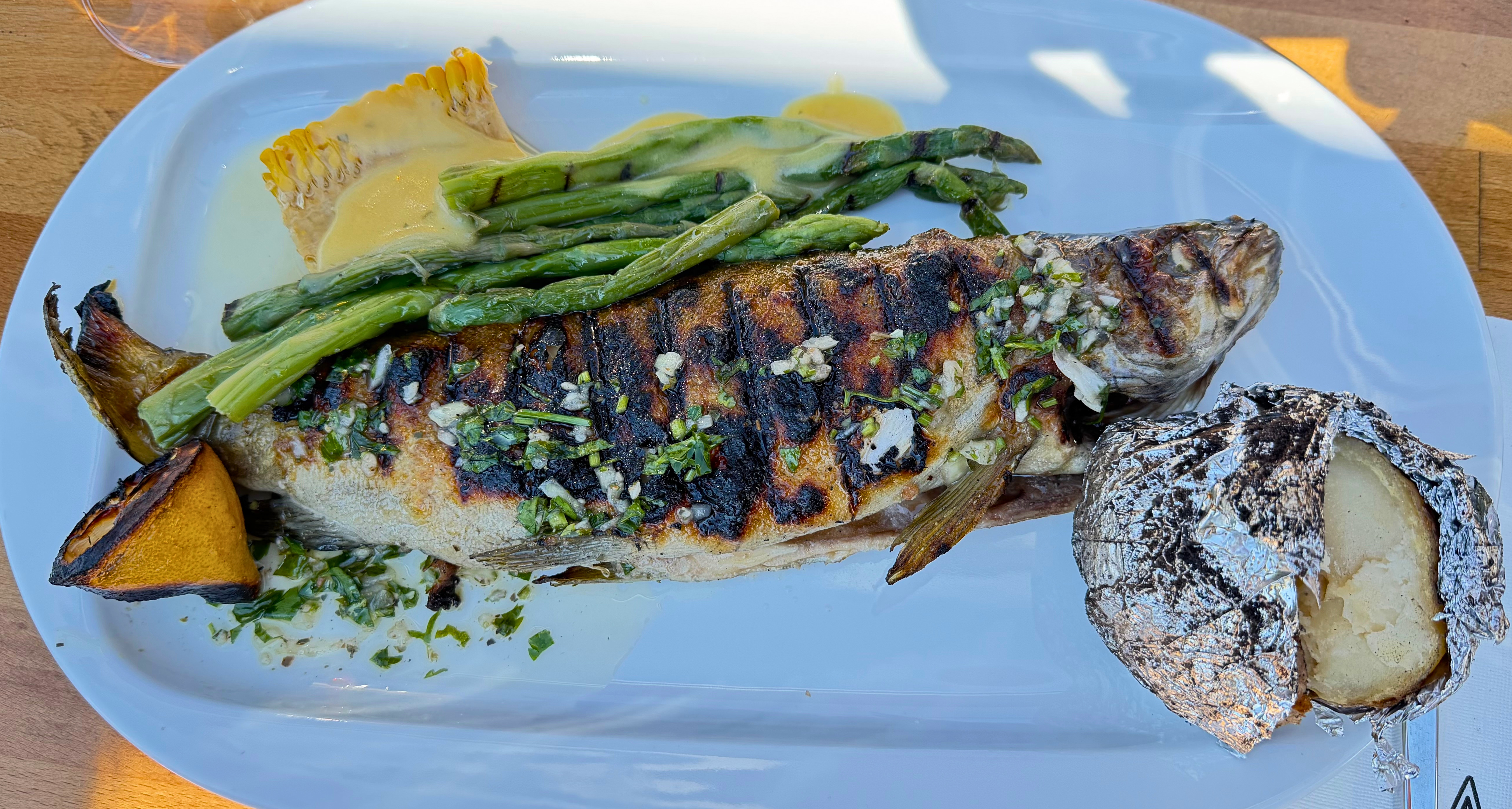 Ohrid trout grilled over wood fire and served beside the lake for Easter lunch.