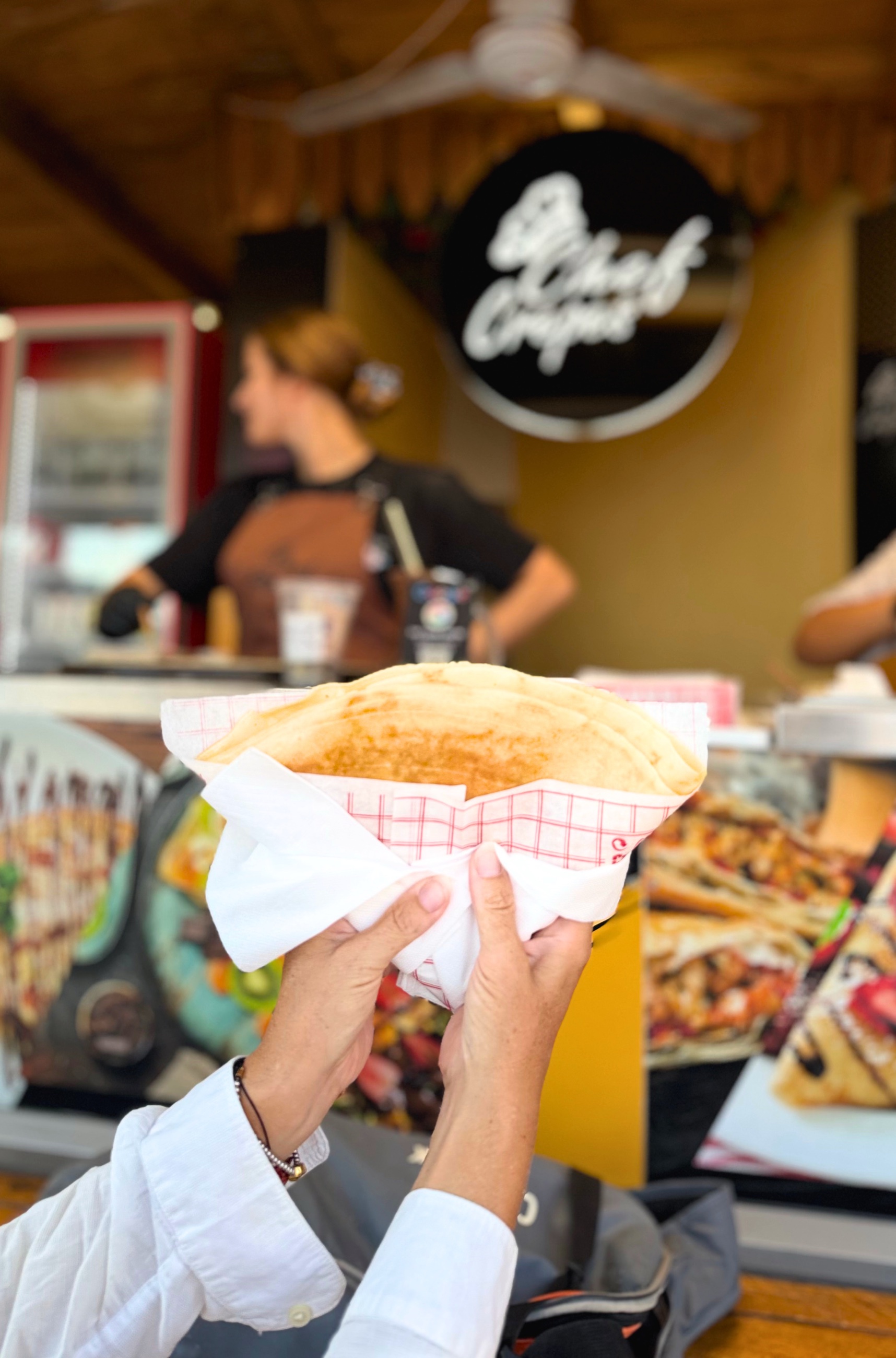 A savory crepe held in front of the Chef Crepes counter along the Sarandë promenade.