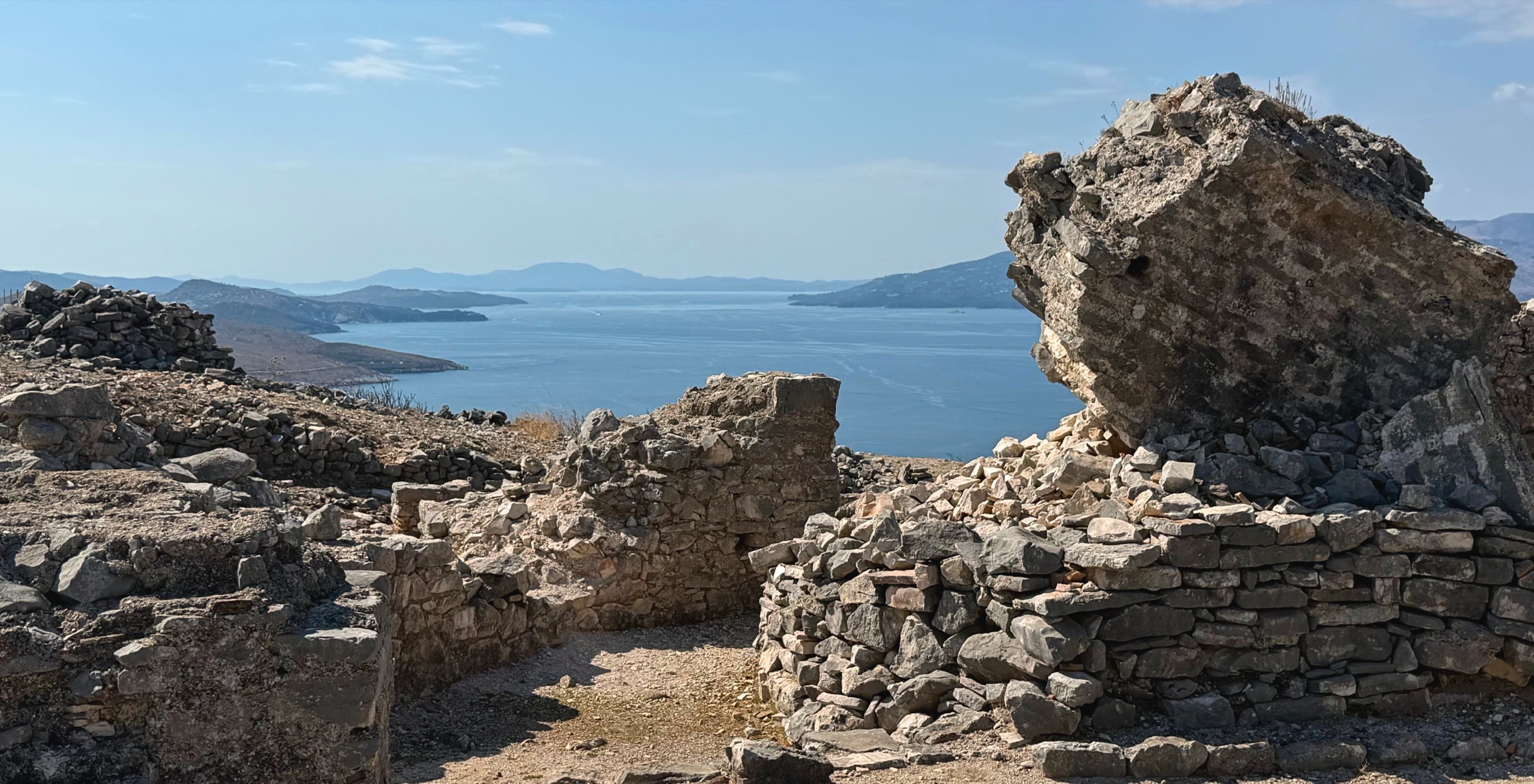 Weathered stone ruins of the Monastery of the Forty Saints above Sarandë, with the Corfu Channel and coastline beyond.