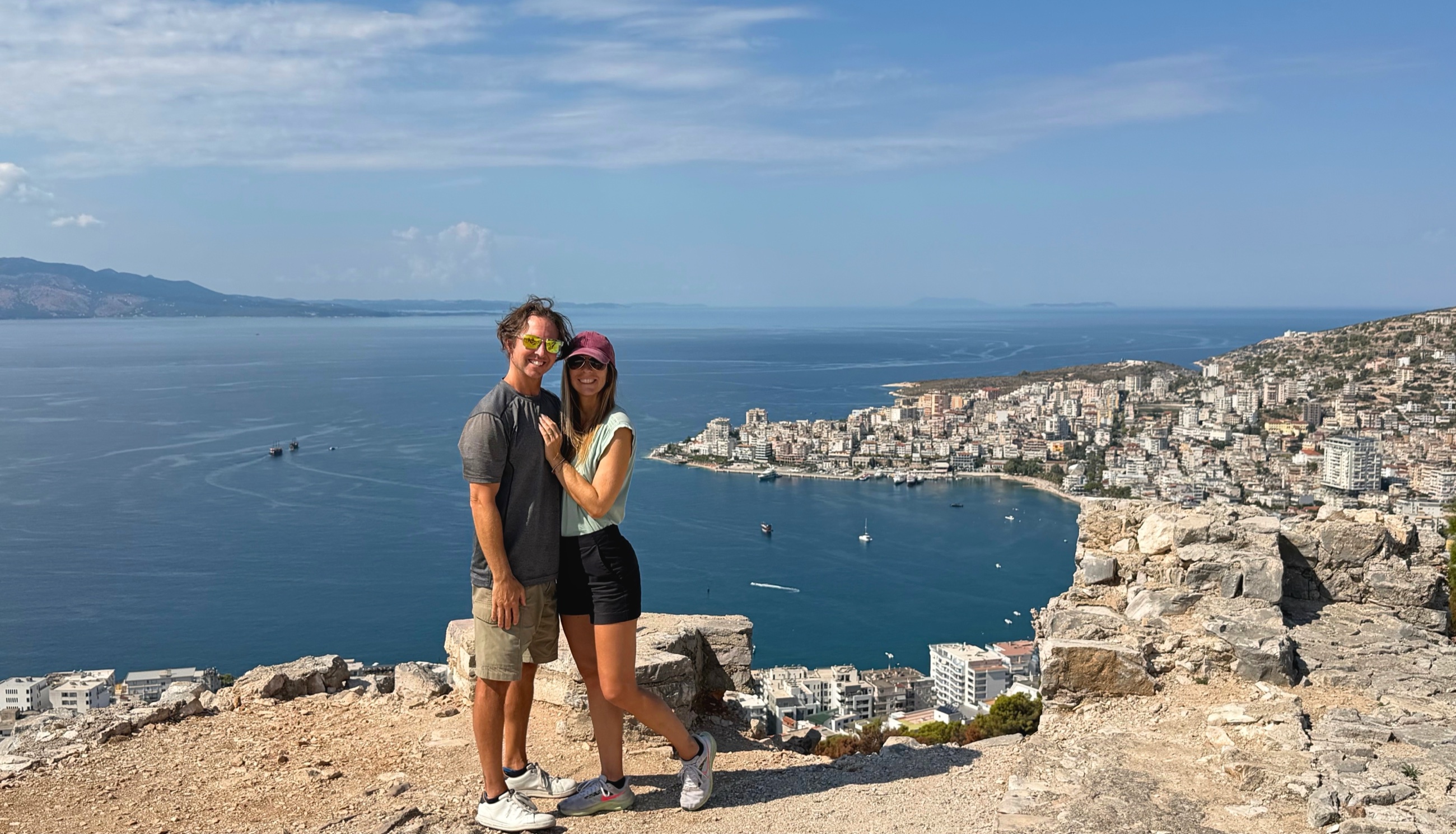 Sam and Stephanie standing at the Monastery of the Forty Saints above Sarandë and the Ionian Sea.