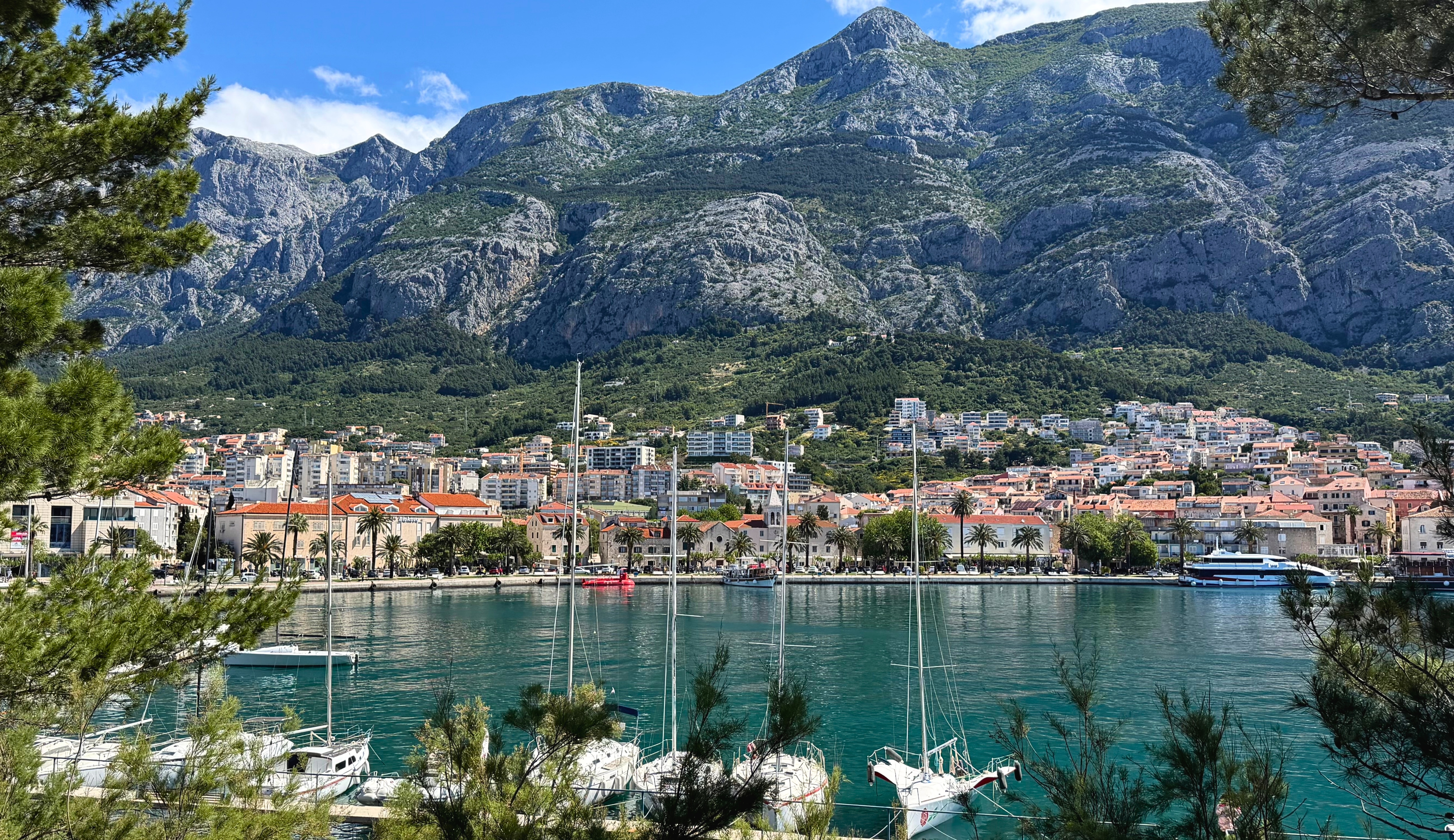 Makarska harbor, old town, and the Biokovo mountains seen from the St. Peter Peninsula.