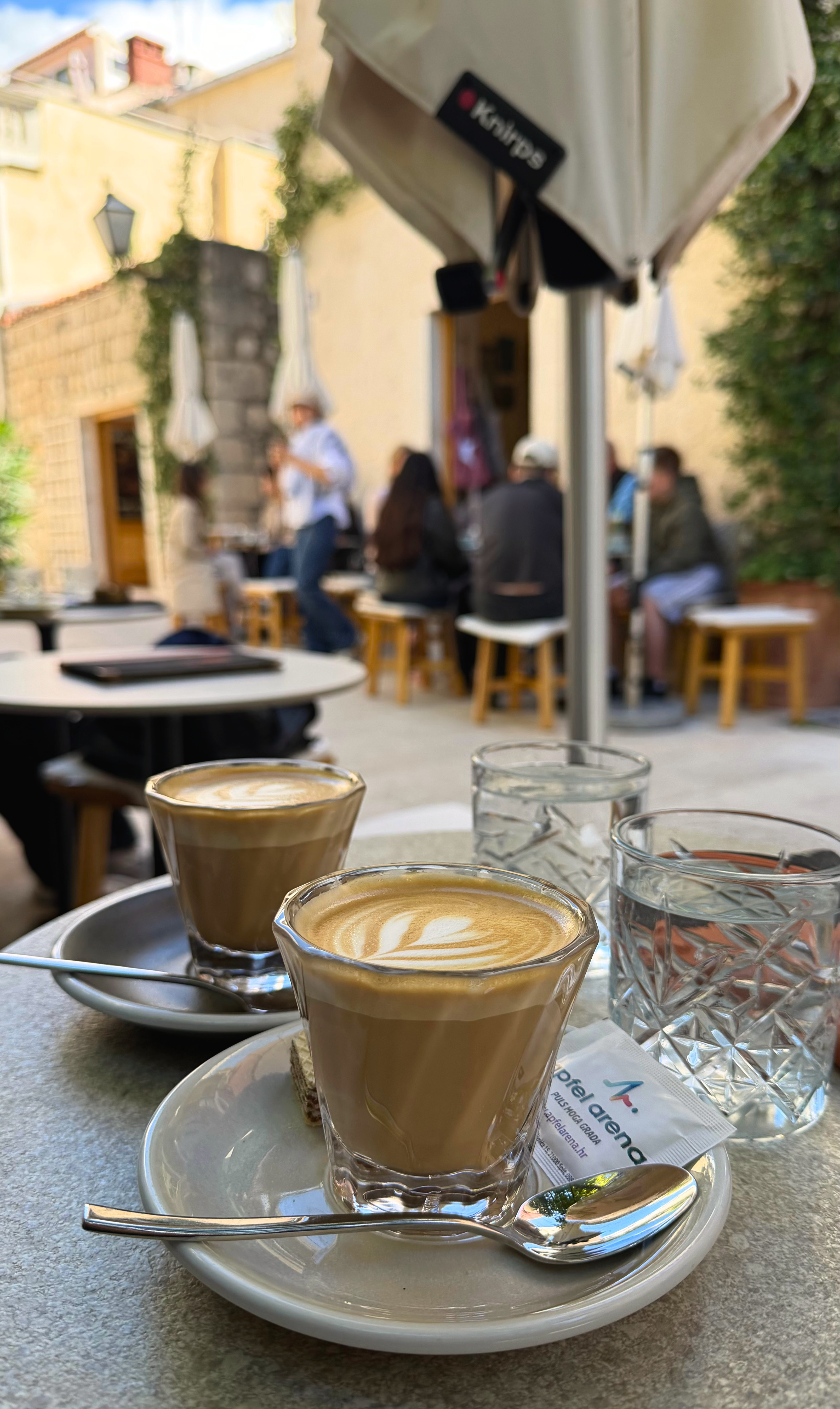 Coffee at Drop in Makarska on a small table in a narrow lane