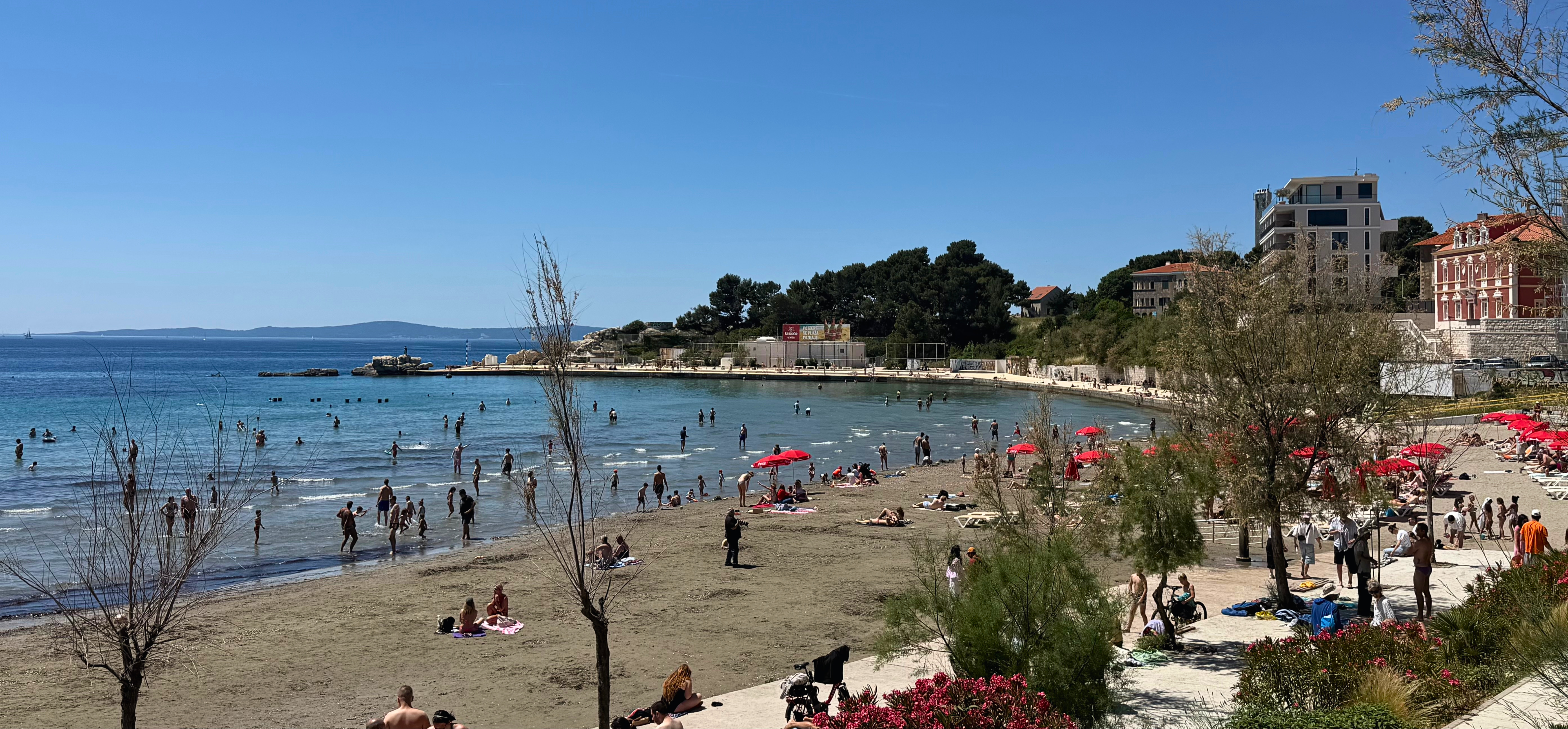 Bačvice beach in Split on a warm afternoon with people gathered in shallow water