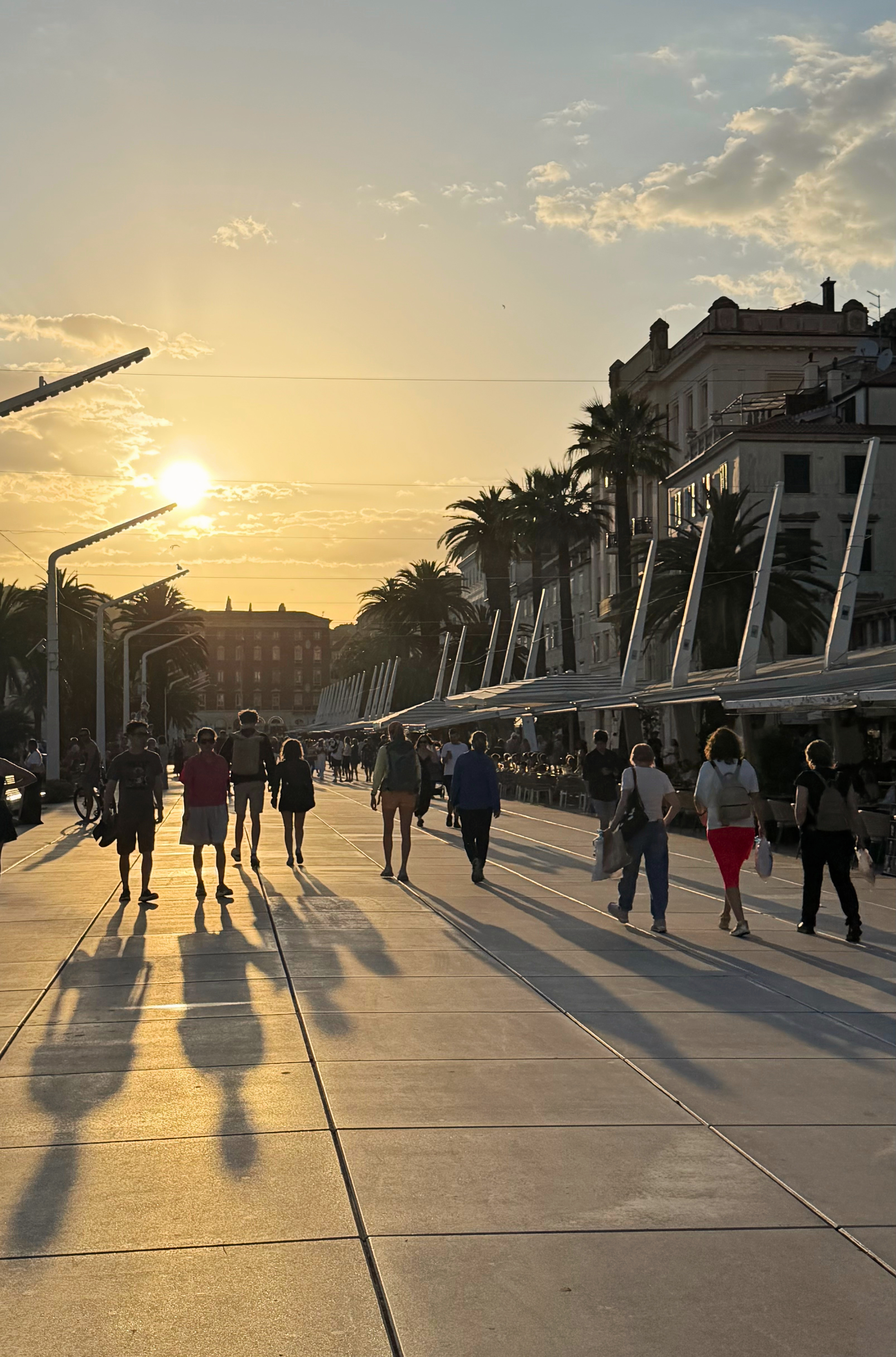 The Riva waterfront in Split near sunset with people walking along the promenade