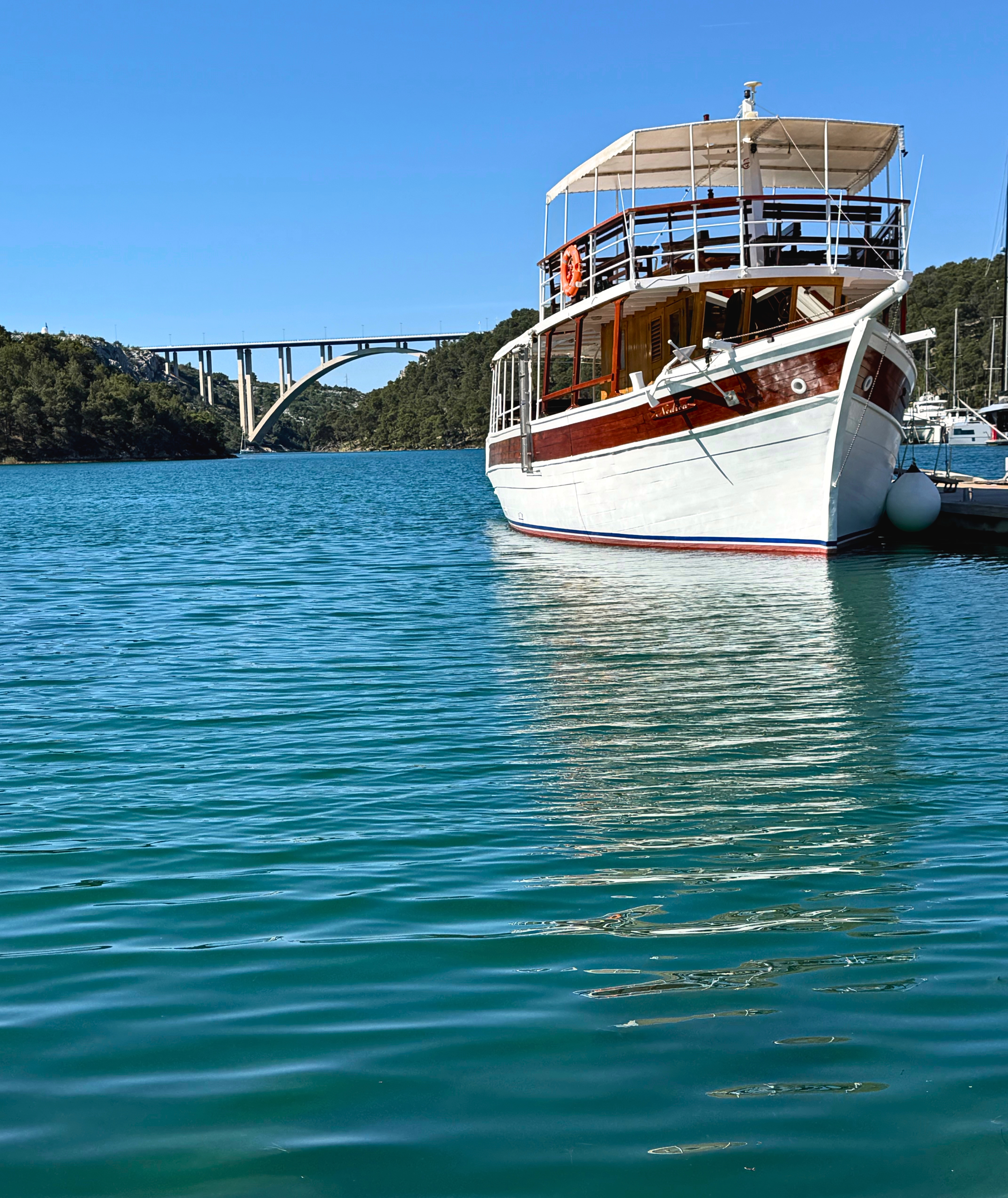 Boat ride from Skradin into Krka National Park, with blue-green river water and wooded banks.