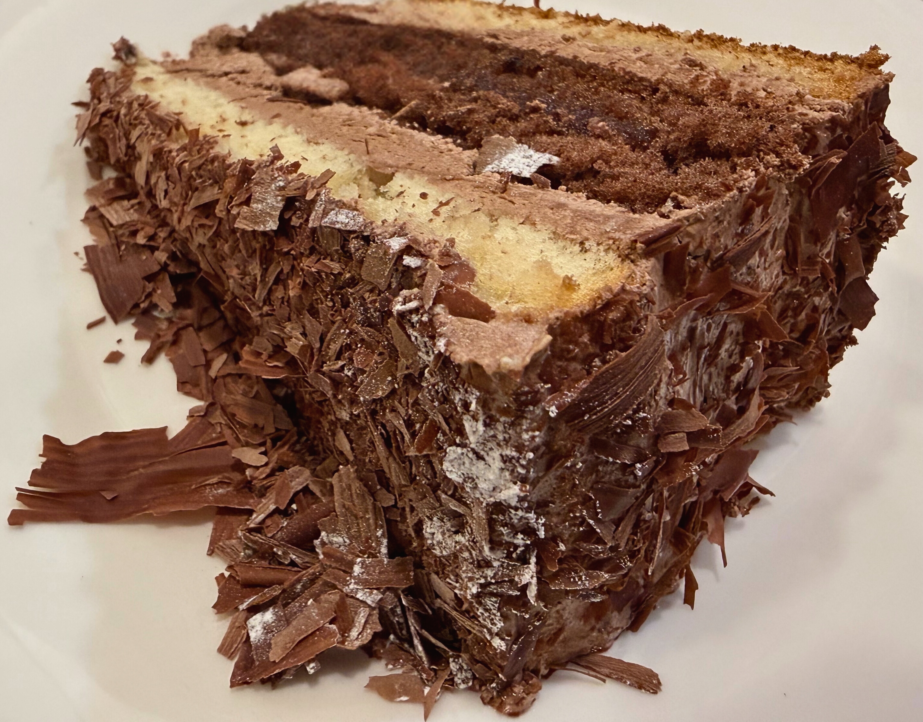A slice of chocolate mousse cake on a white plate at Café Palmelita.