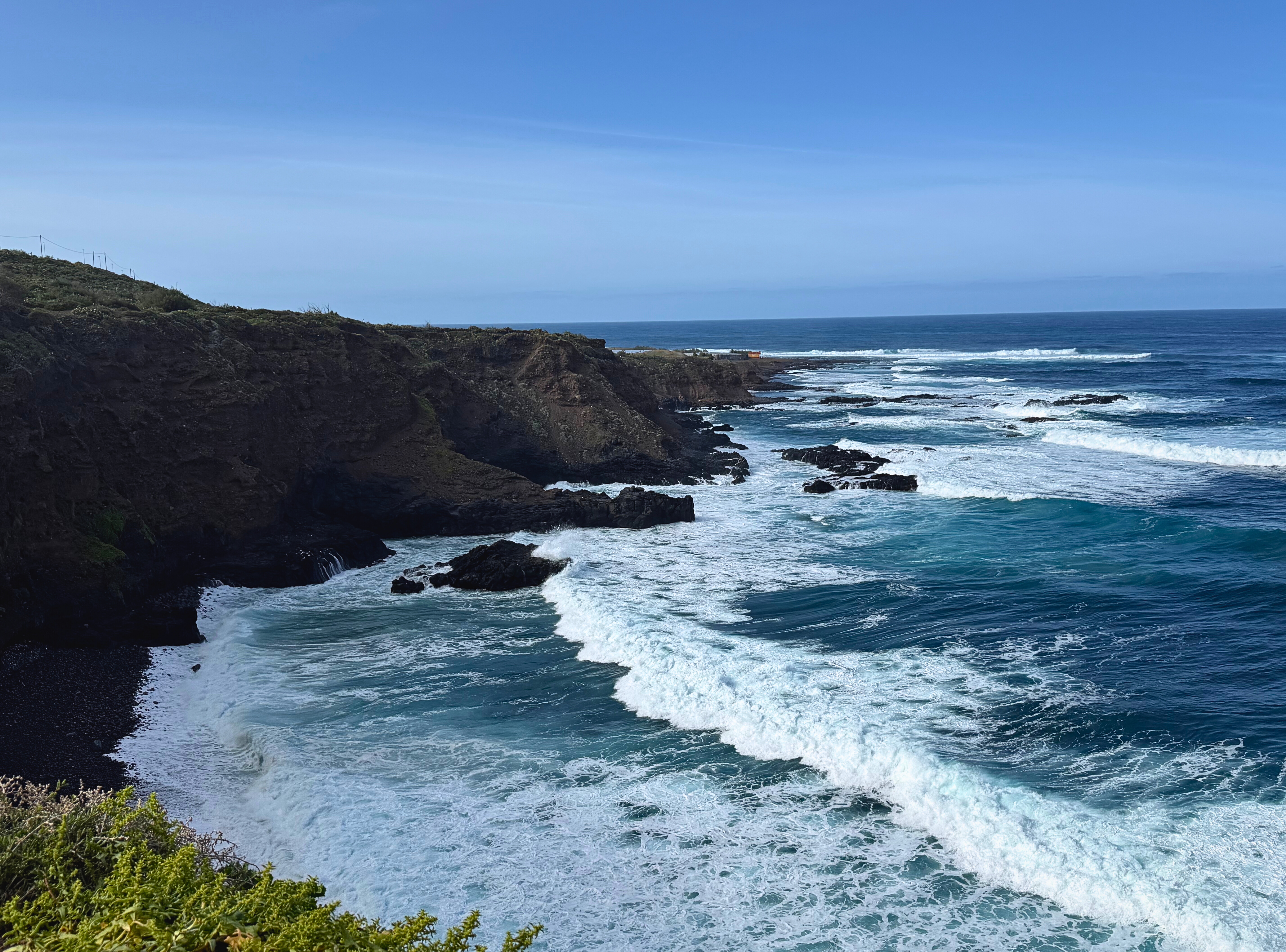 Rugged lava cliffs and Atlantic surf along the Anaga coastline in Tenerife.