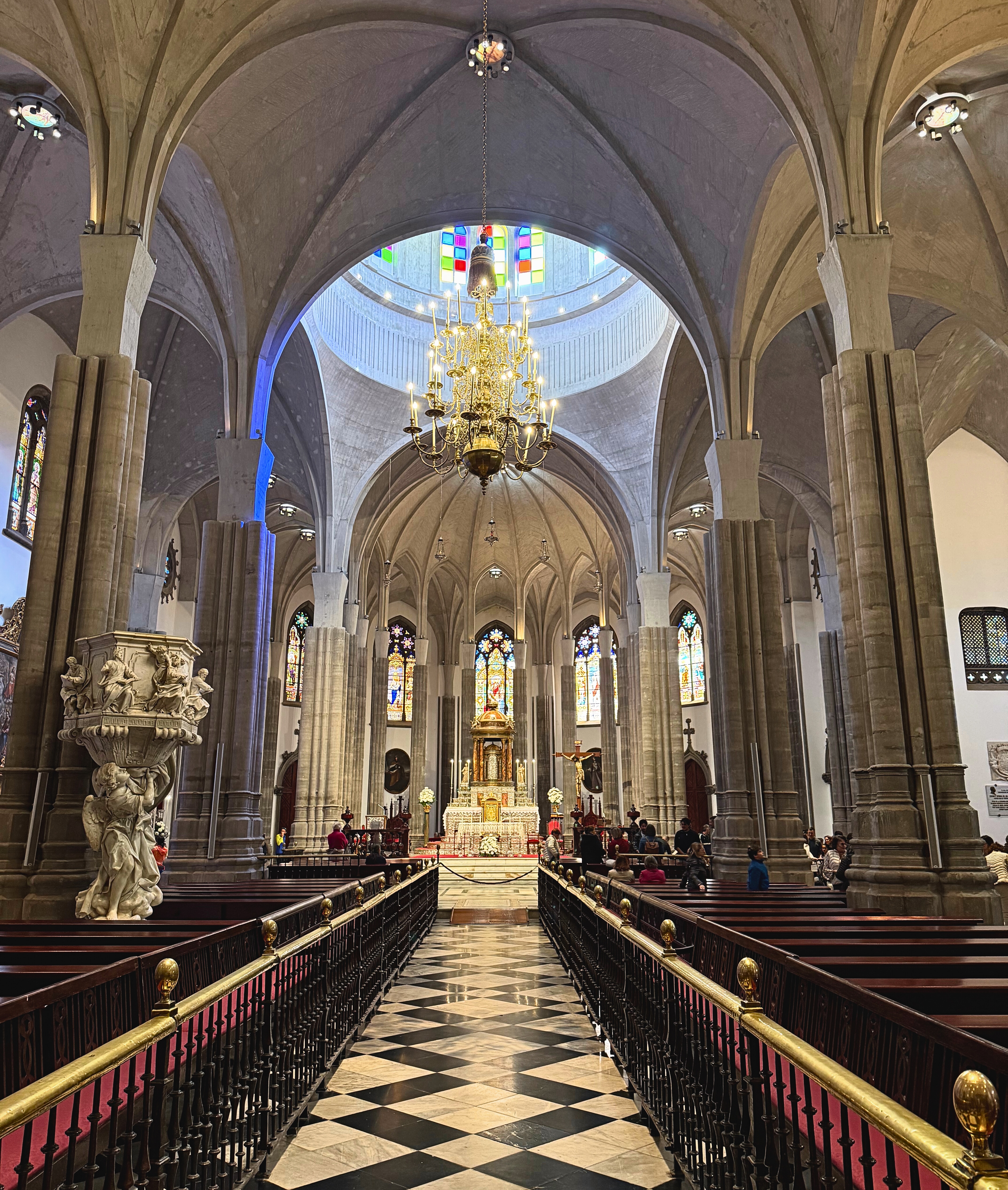 The interior of the Cathedral of La Laguna with stone arches, stained glass, and pews.