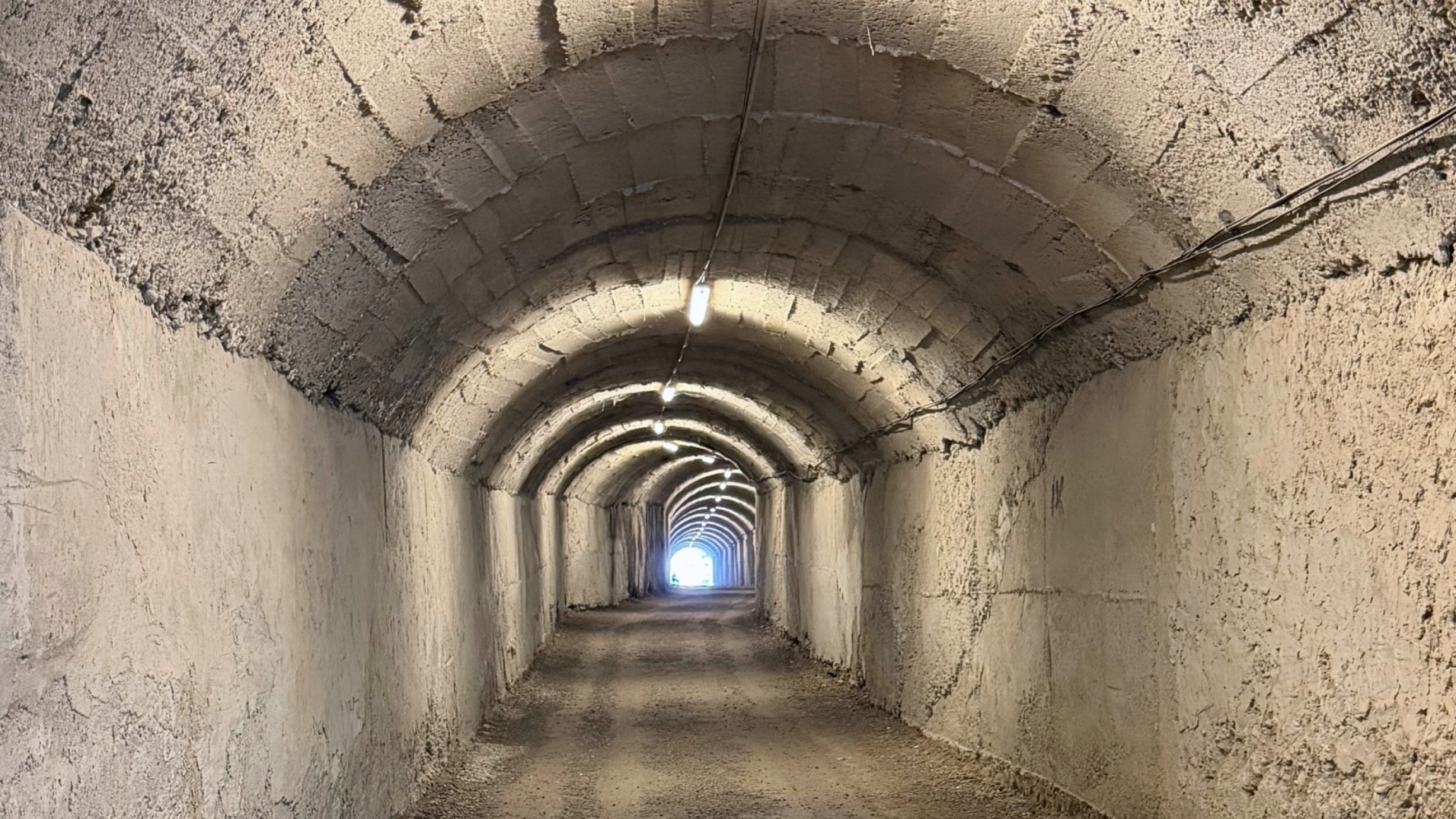 The arched concrete entrance tunnel leading into Bunk'Art 1 beneath Mount Dajti near Tirana.