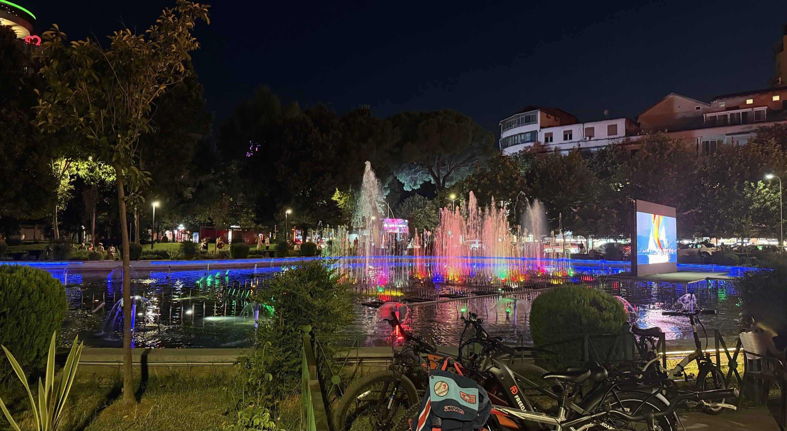 Rinia Park illuminated at night in central Tirana.