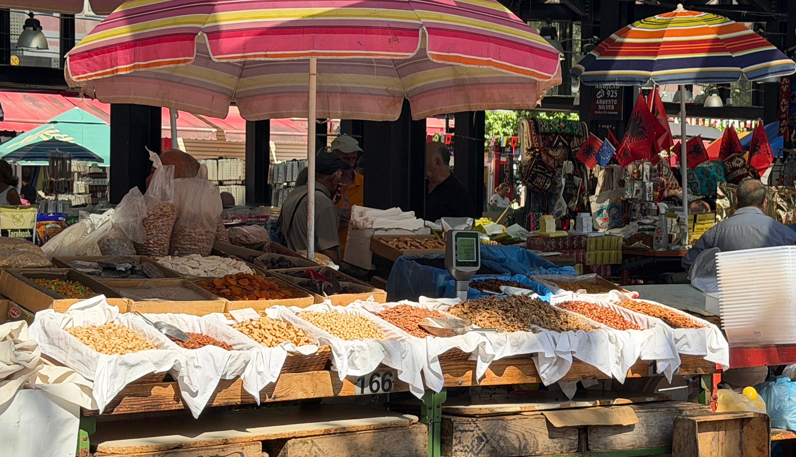 A produce stall under umbrellas in Tirana's New Bazaar.