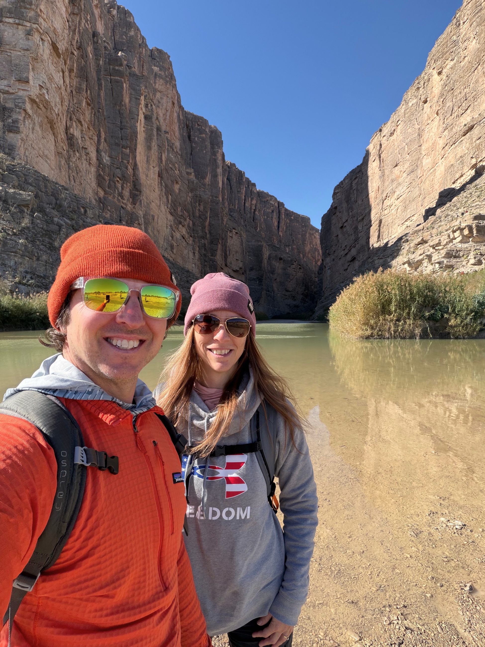 A couple standing together inside Santa Elena Canyon in Big Bend National Park.