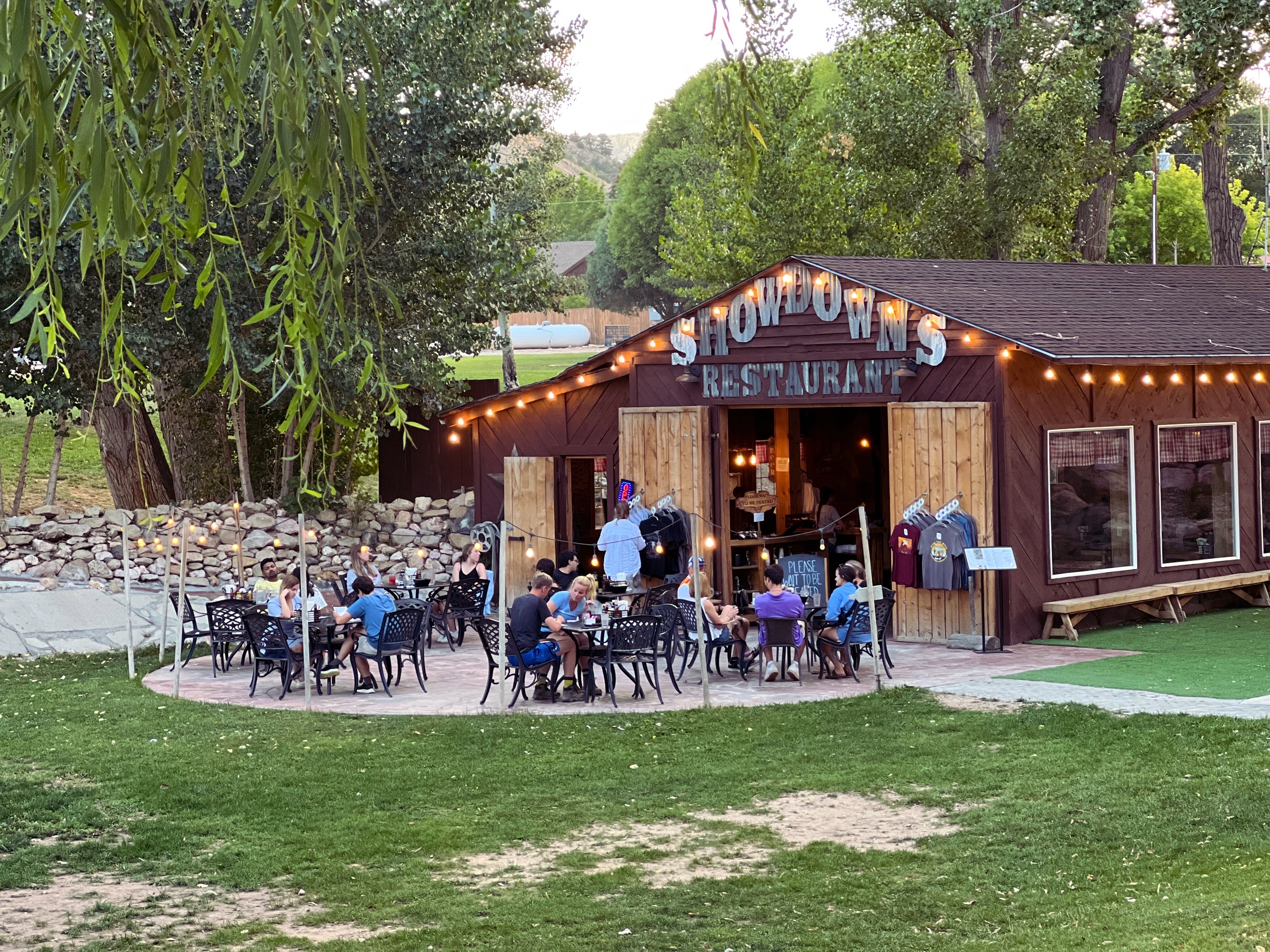Outdoor tables, a fire pit, and live music at Showdowns restaurant in Tropic, Utah.