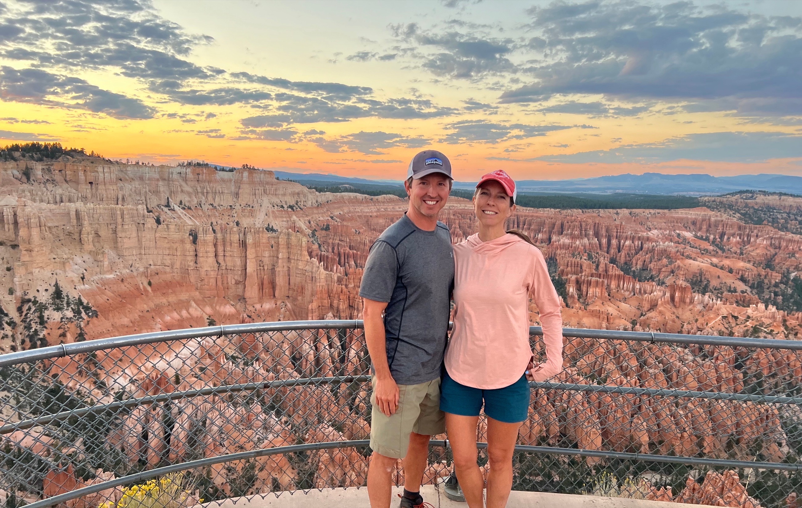 Sam and Stephanie at Bryce Point near sunset with Bryce Canyon Amphitheater behind them.