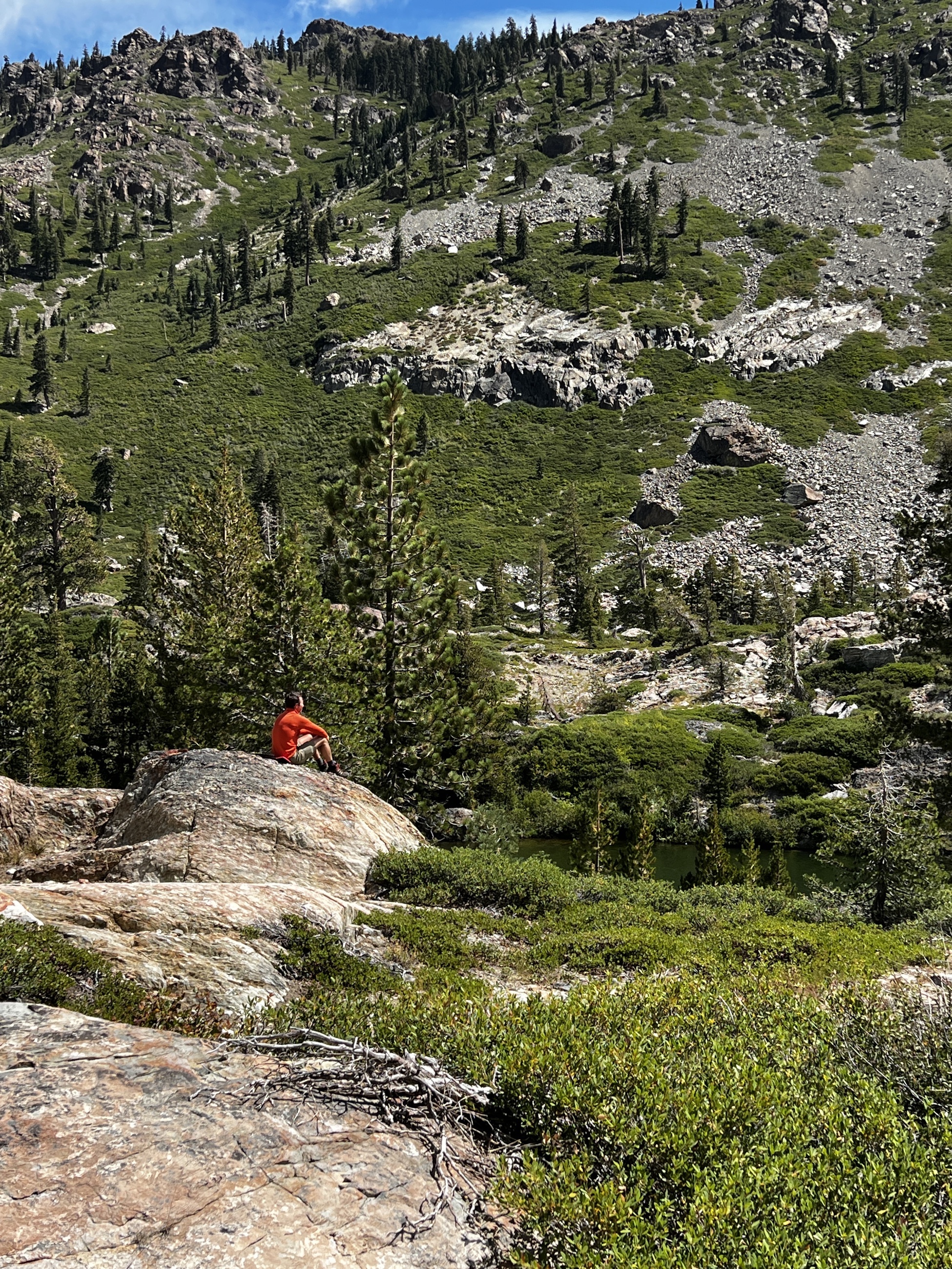 Sam sitting on a granite boulder below the rocky slopes of Mount Elwell in California's Lakes Basin.