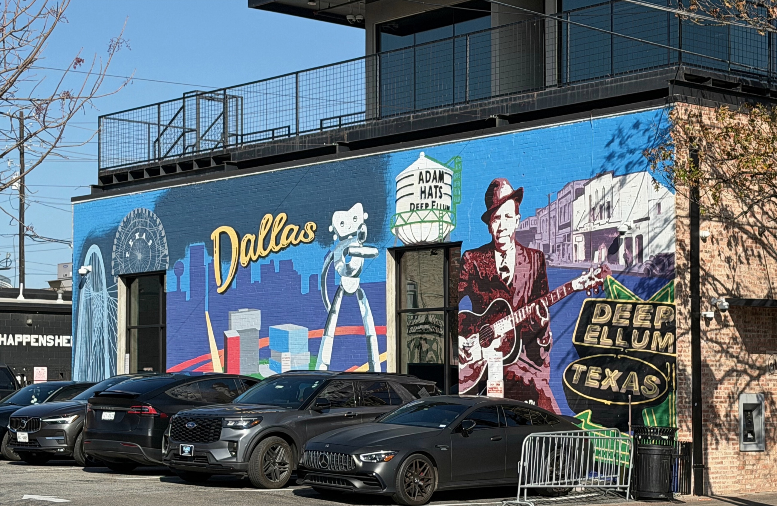A colorful mural painted on brick in Deep Ellum.