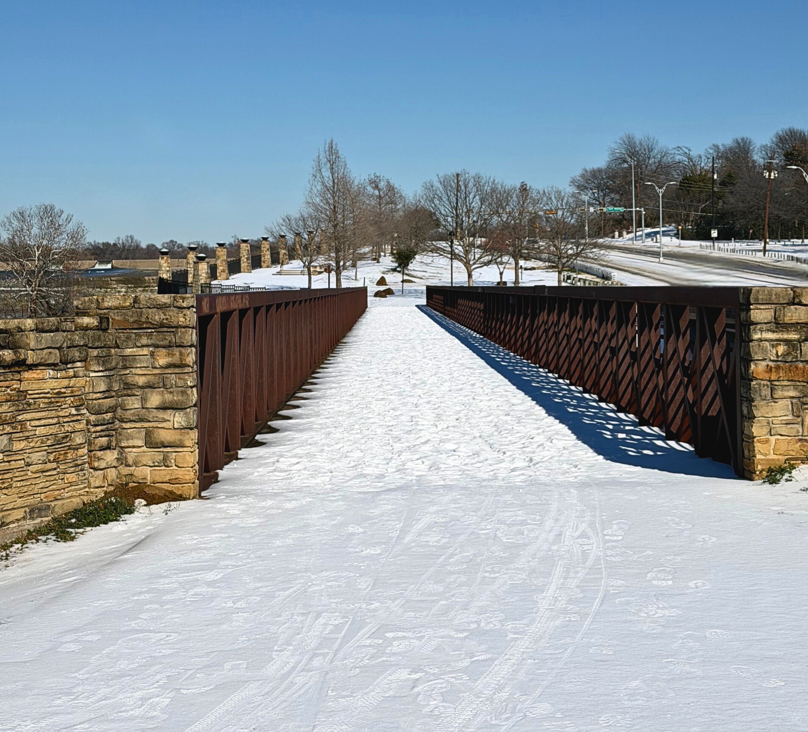 Snow and ice on a bridge across the spillway at White Rock Lake.