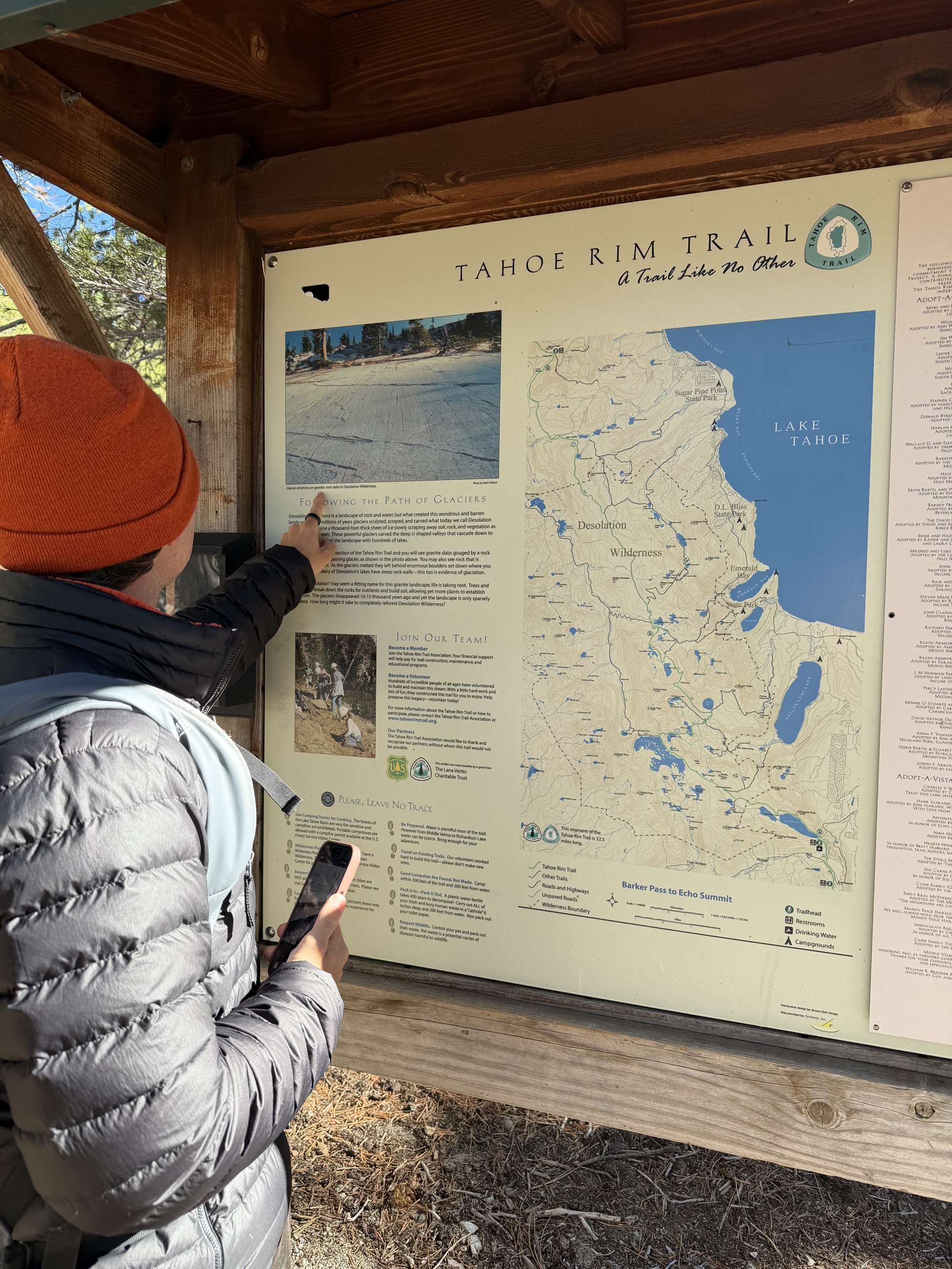 Sam reviewing the Tahoe Rim Trail and Desolation Wilderness map at the trailhead.