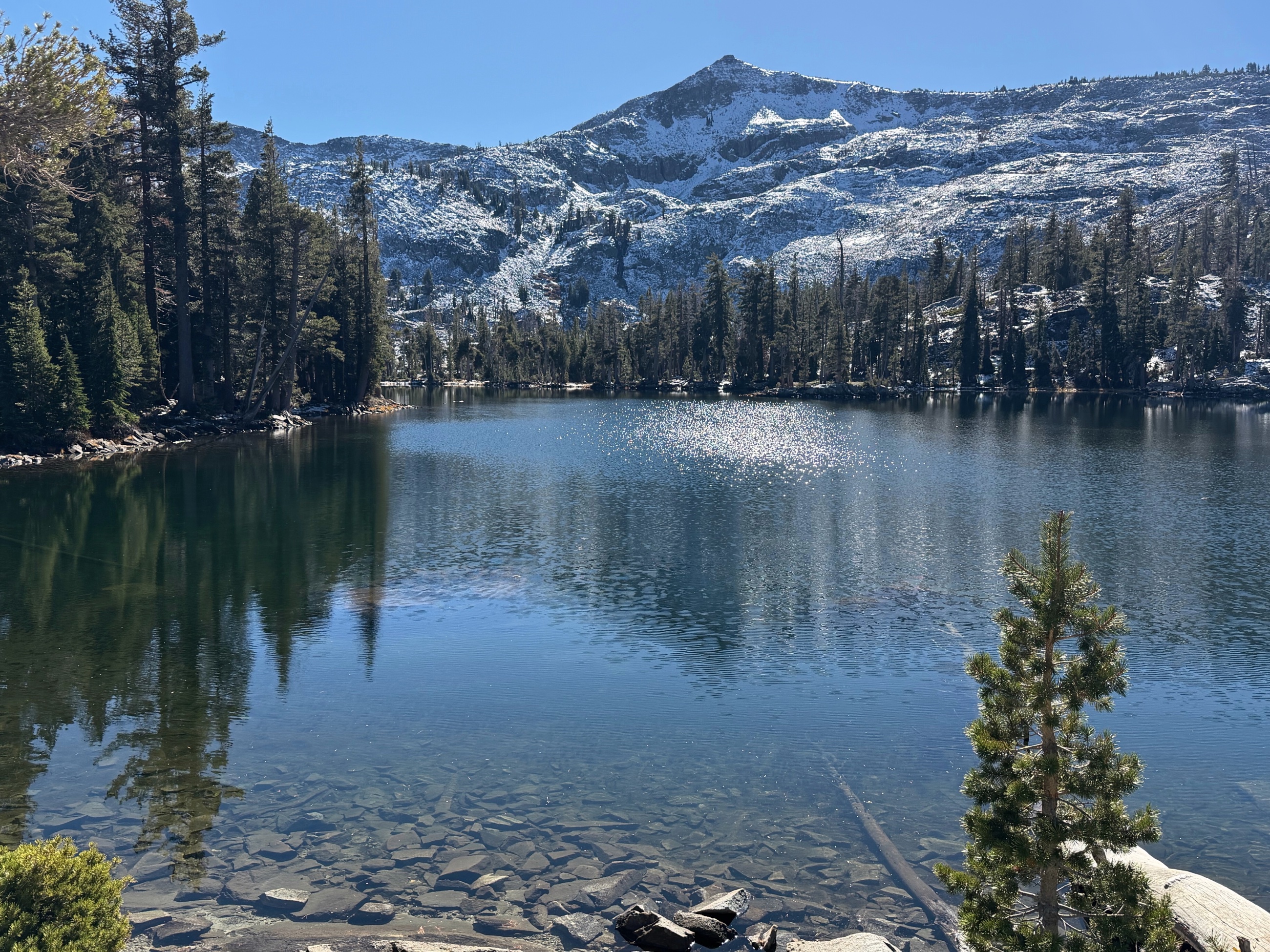Tamarack Lake beneath snow-covered granite slopes.