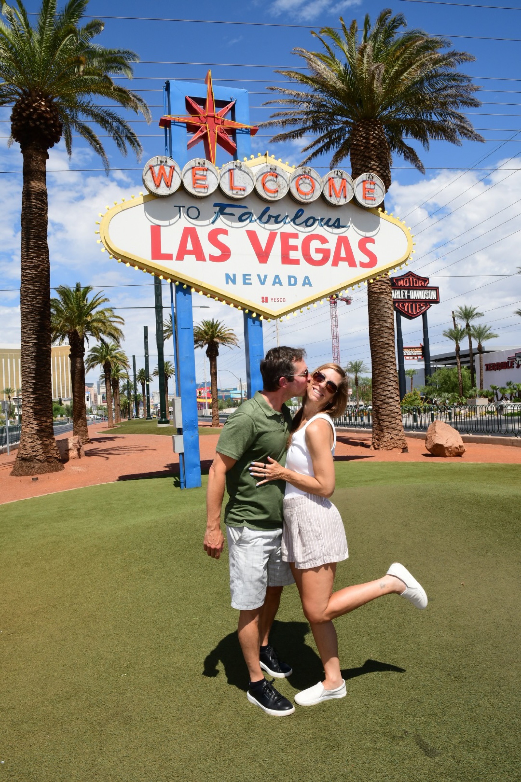 The Welcome to Fabulous Las Vegas sign with visitors gathered nearby.