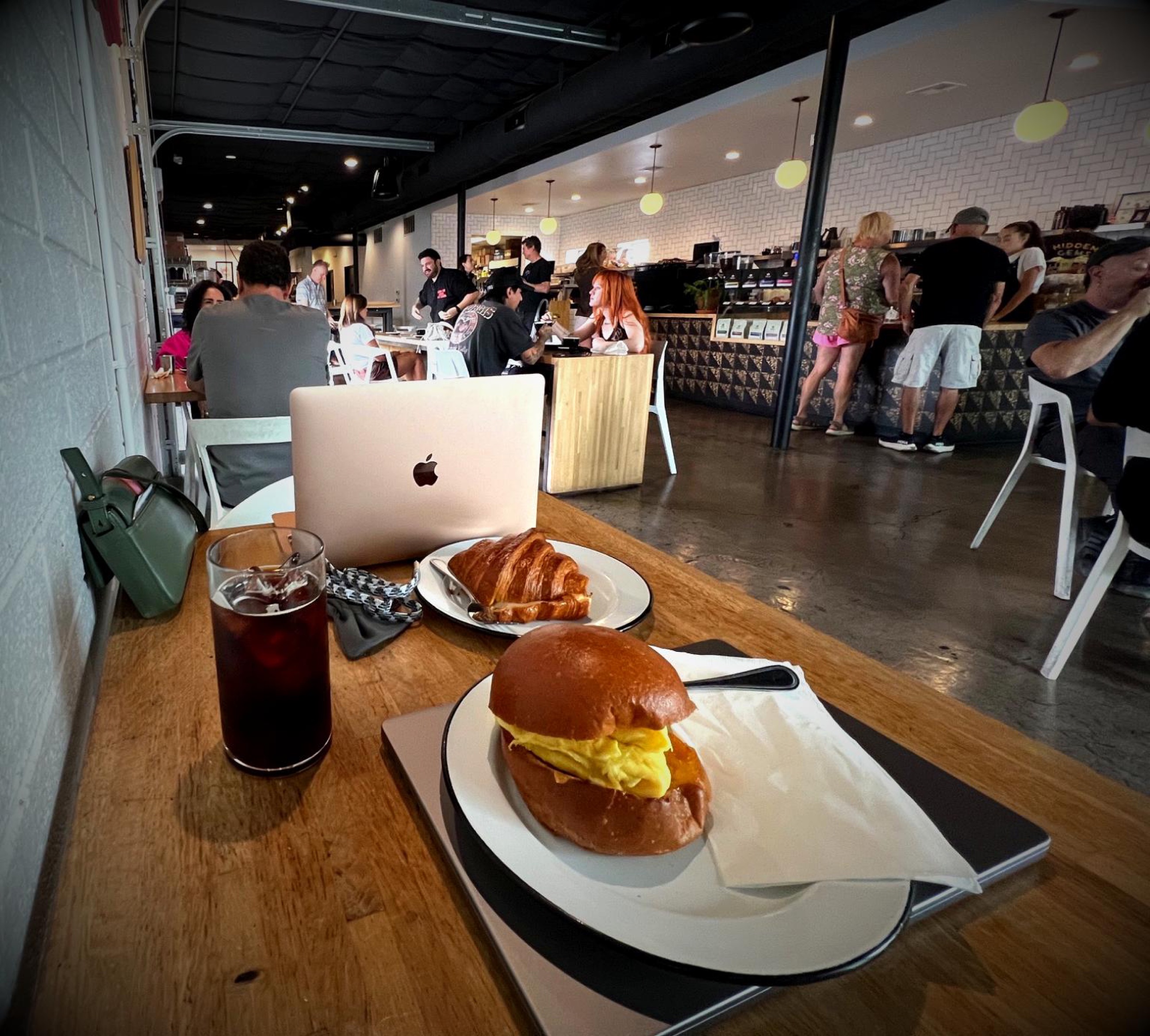 Breakfast sandwiches and iced coffee on a table at Vesta Coffee Roasters in Las Vegas.