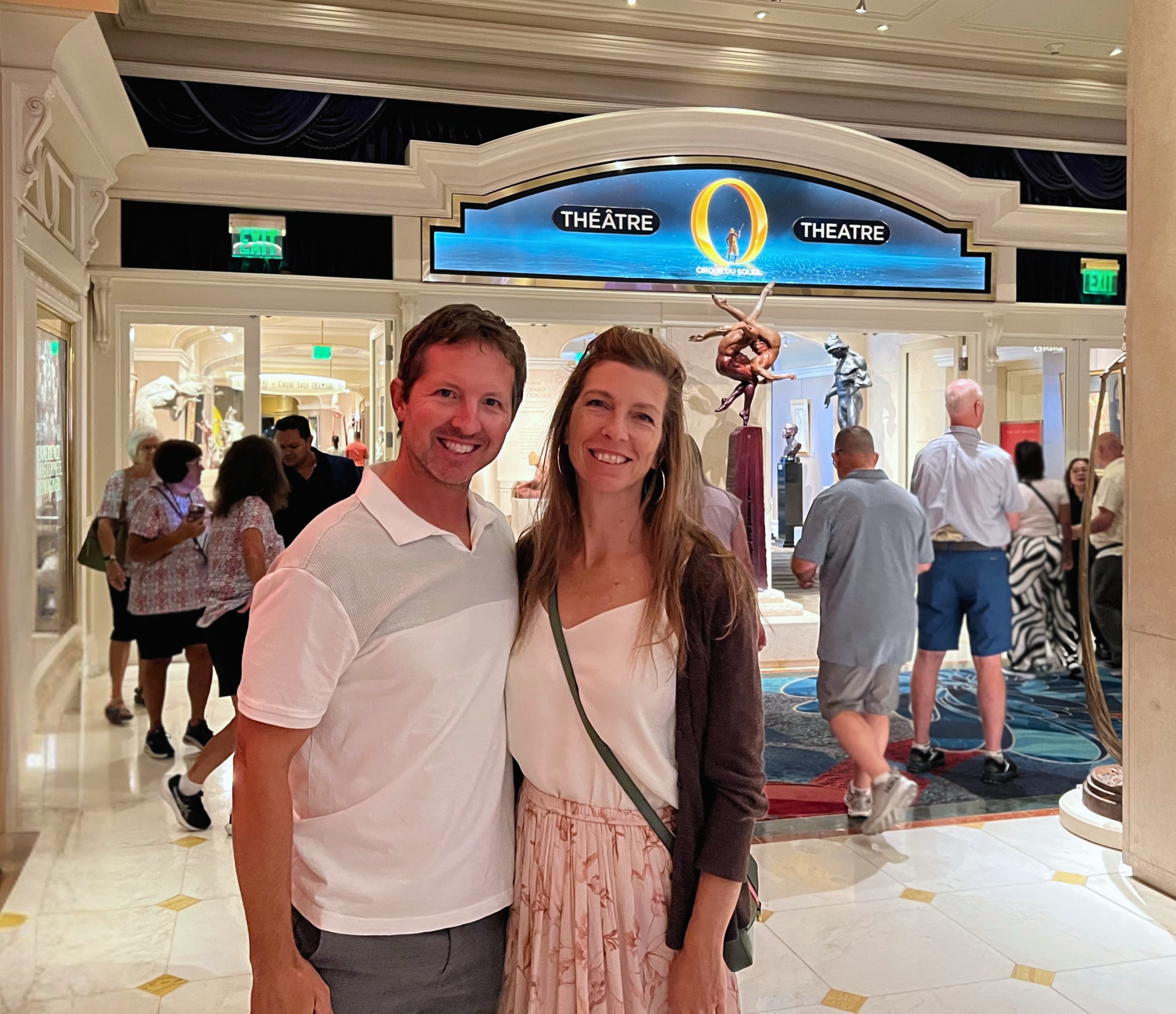 Sam and Stephanie standing outside the Bellagio theater entrance before seeing O by Cirque du Soleil.